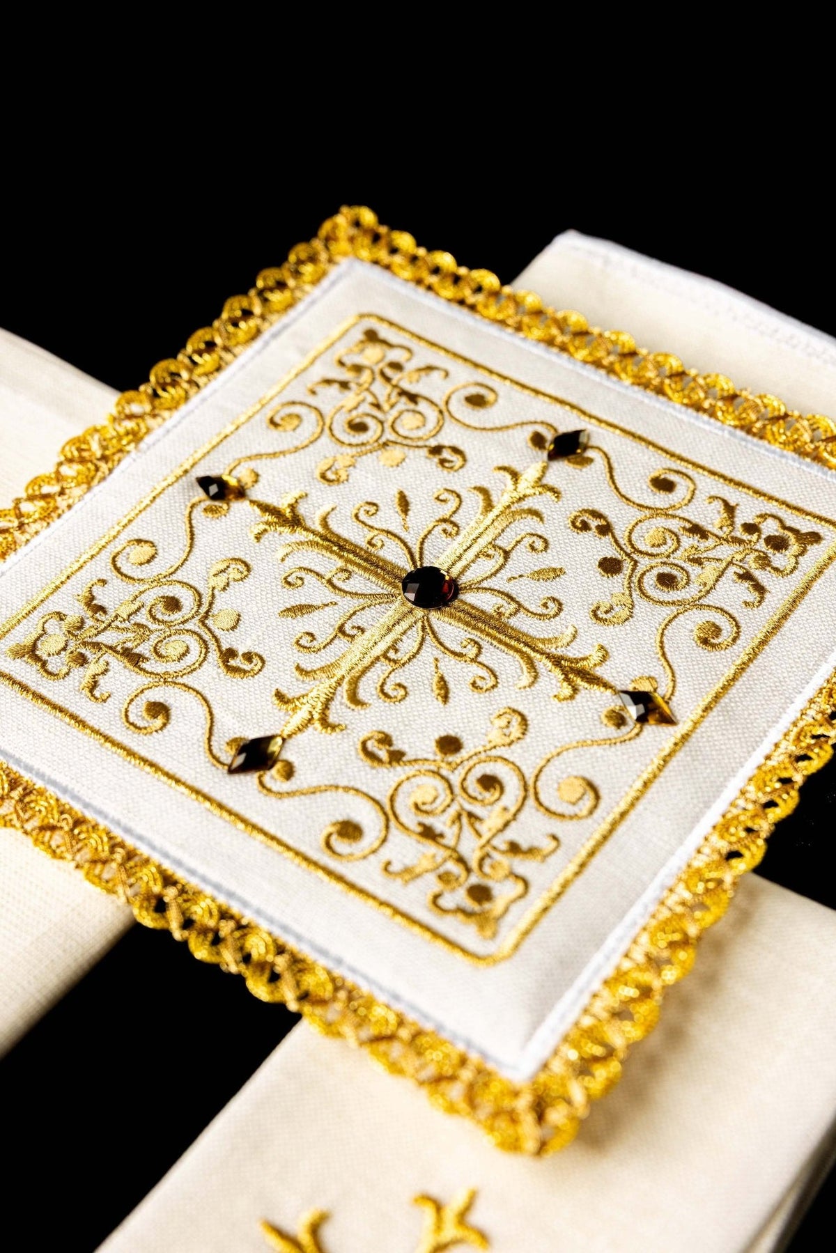 Altar linen set detail showing a gold cross on white linen fabric