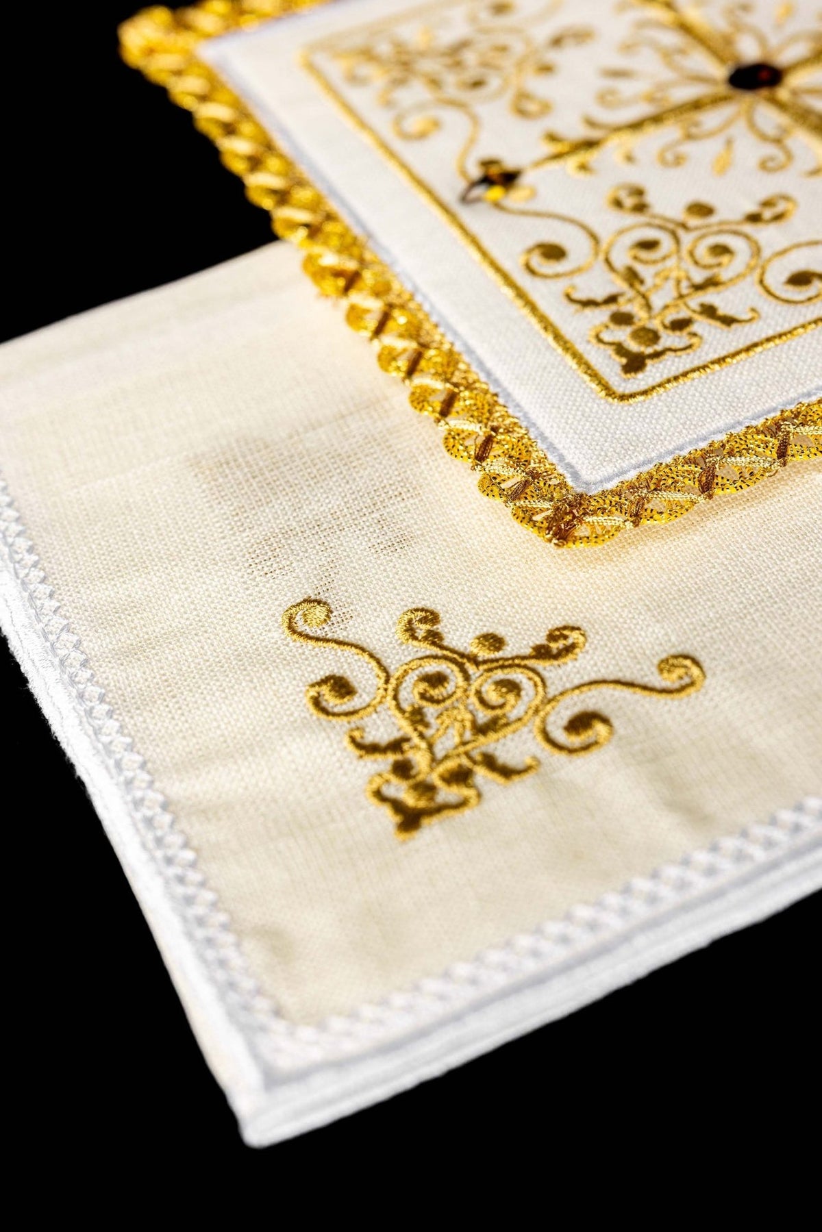 Altar linen set close-up showing gold ornamental embroidery and decorative edging