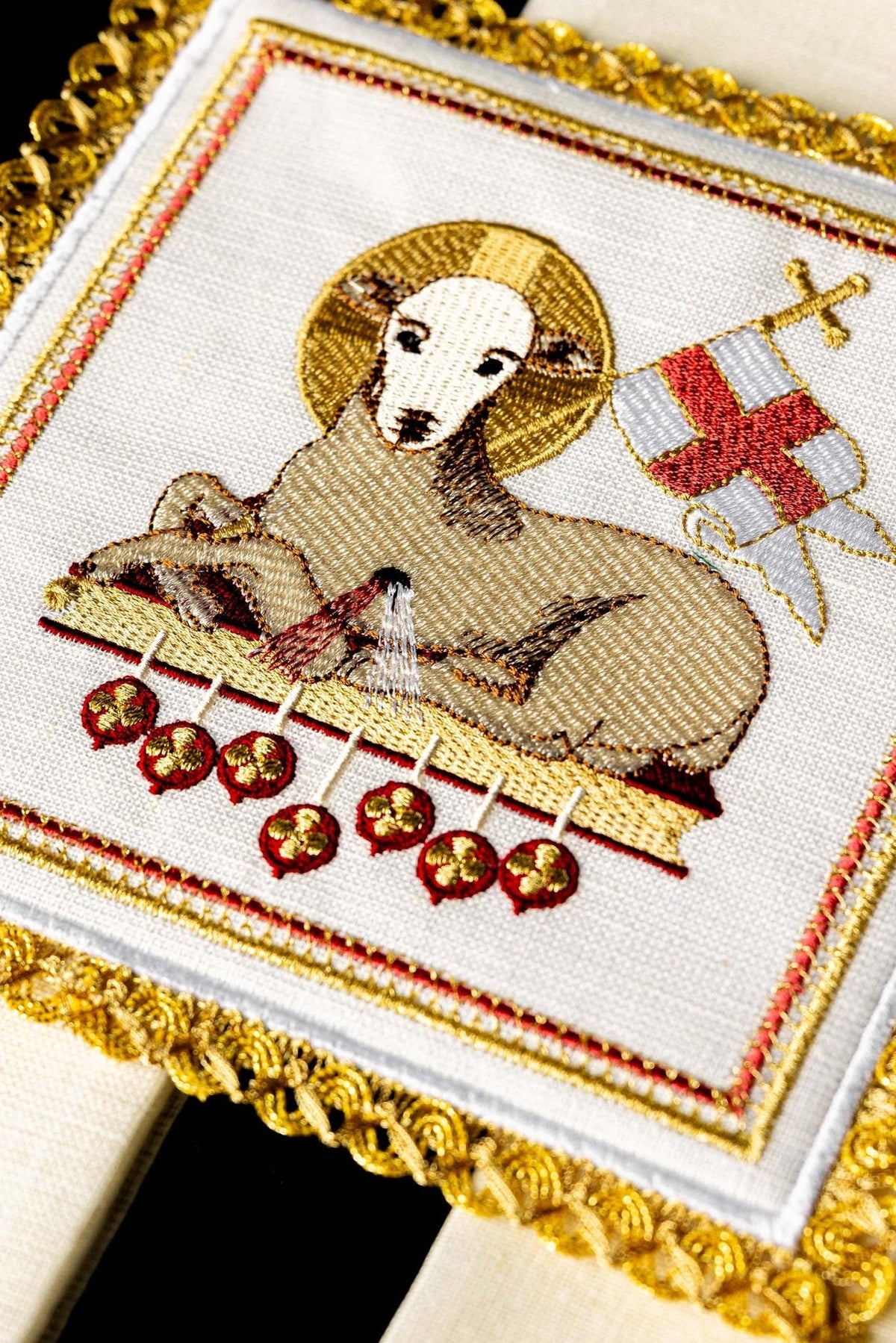 Altar linen set close-up of lamb embroidery with gold halo, cross, and red accents