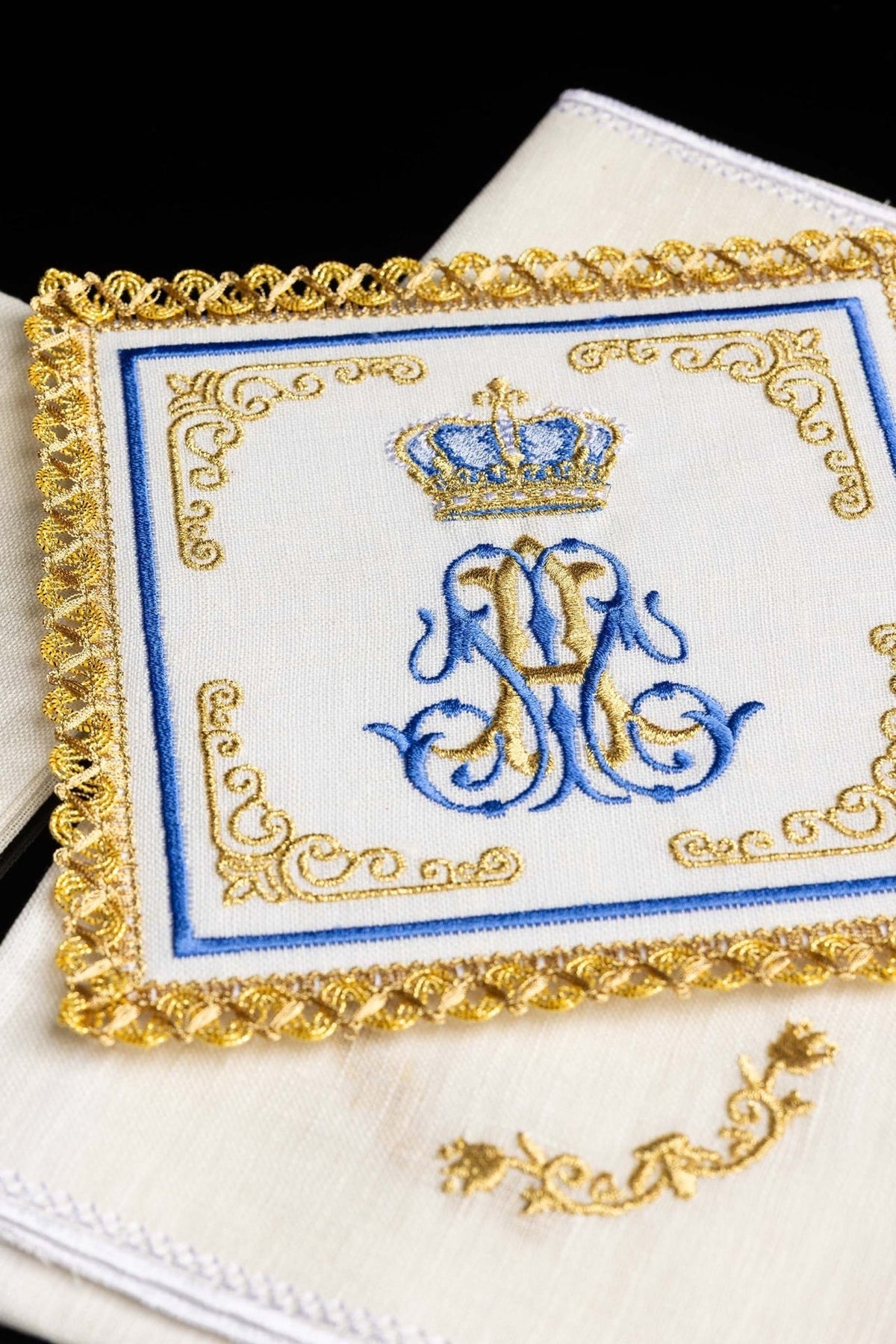 Altar linen set close-up showing blue and gold Marian motif embroidery with ornate gold trim
