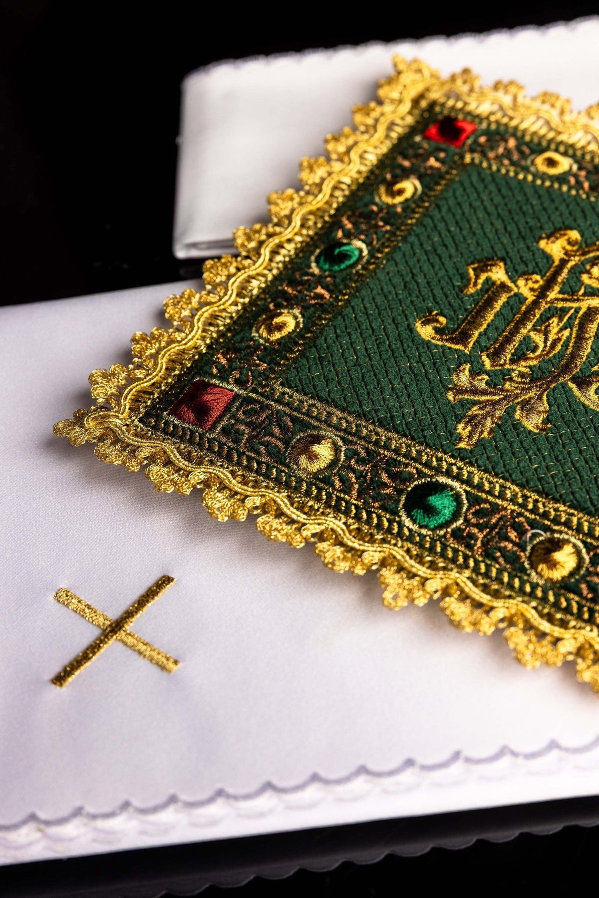 Green velvet altar linen set detail showing gold cross on a white linen cloth