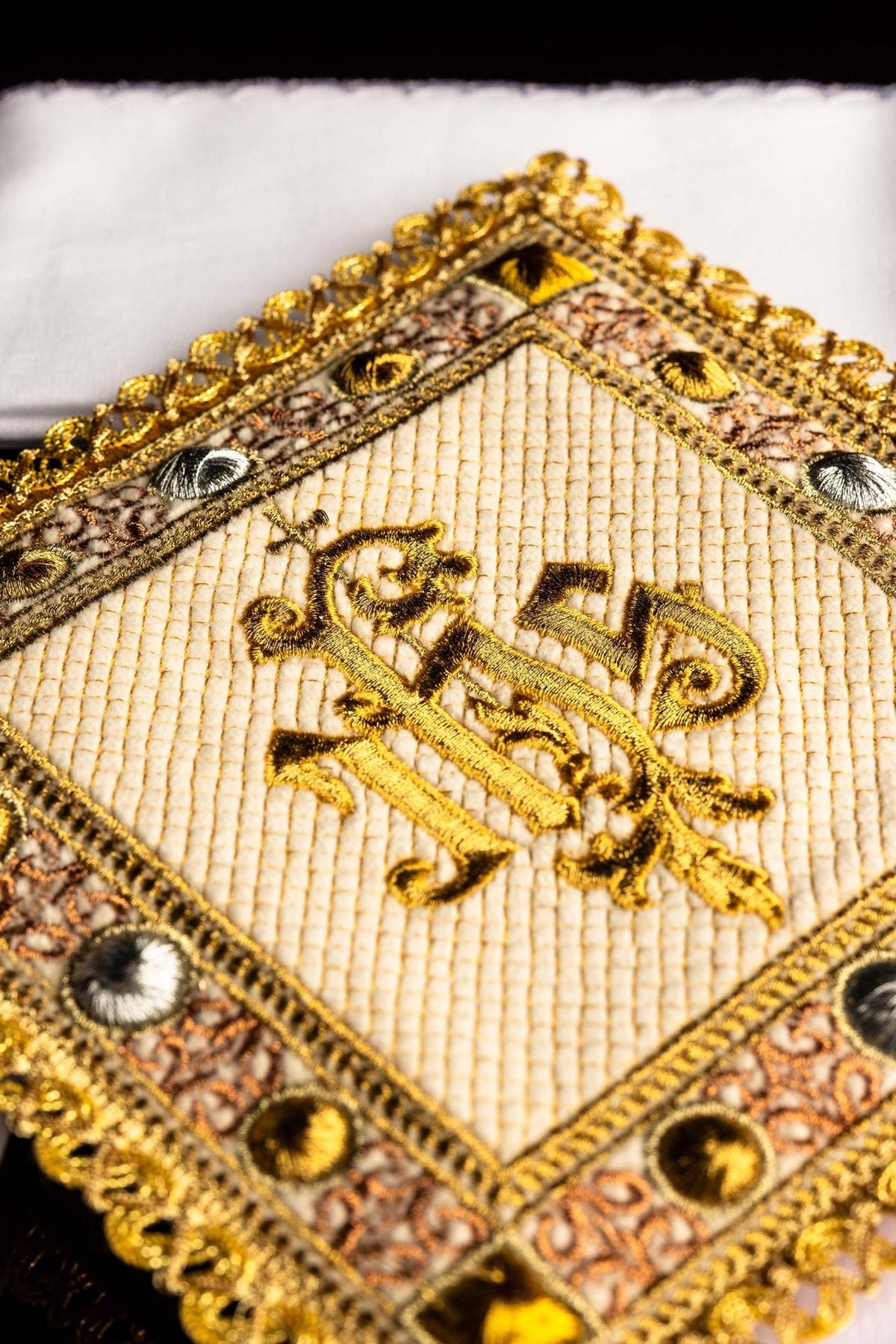 Altar linen set close-up of embroidered gold IHS symbol and ornate border