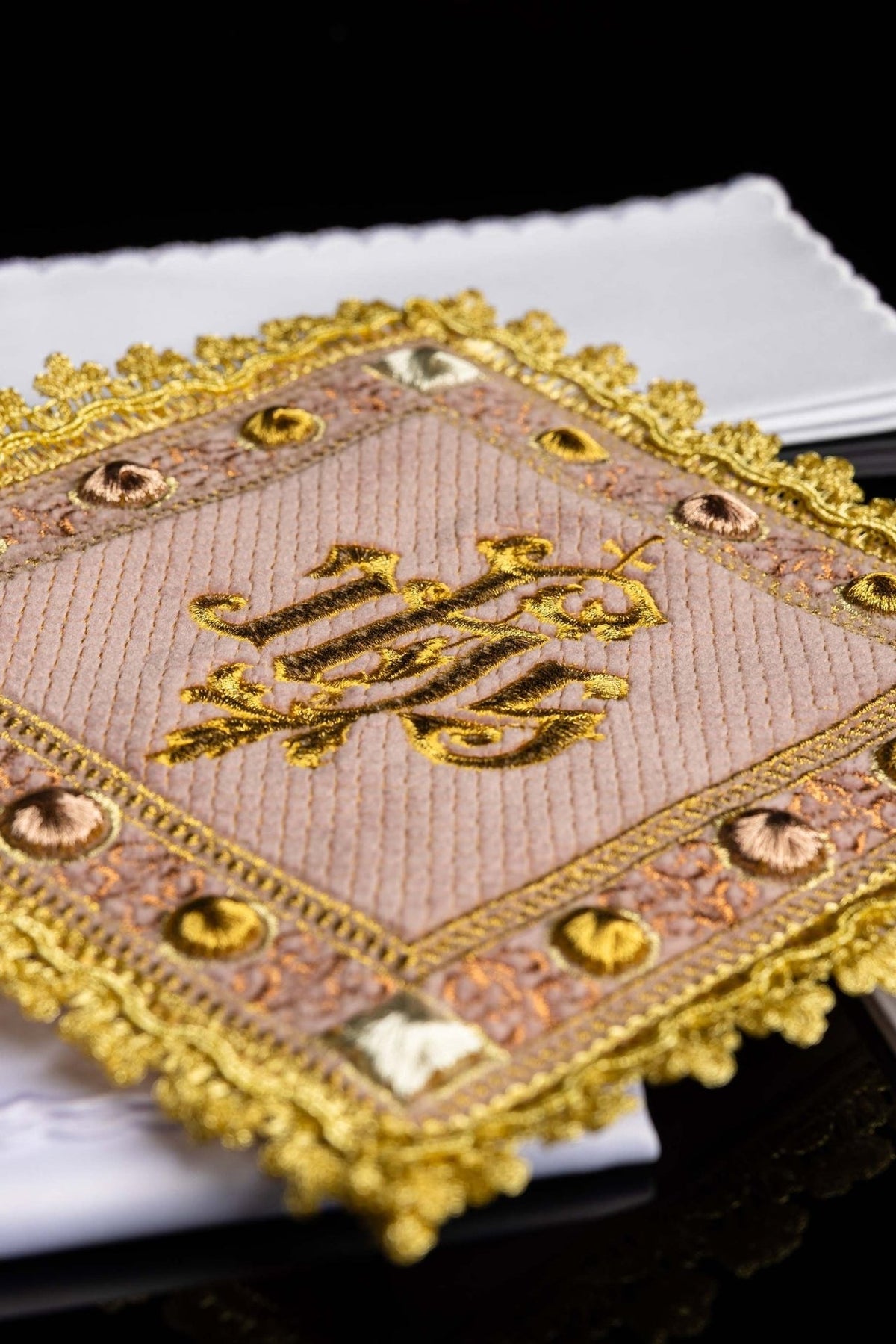 Rose velvet corporal close-up showing embroidered IHS symbol and decorative gold border