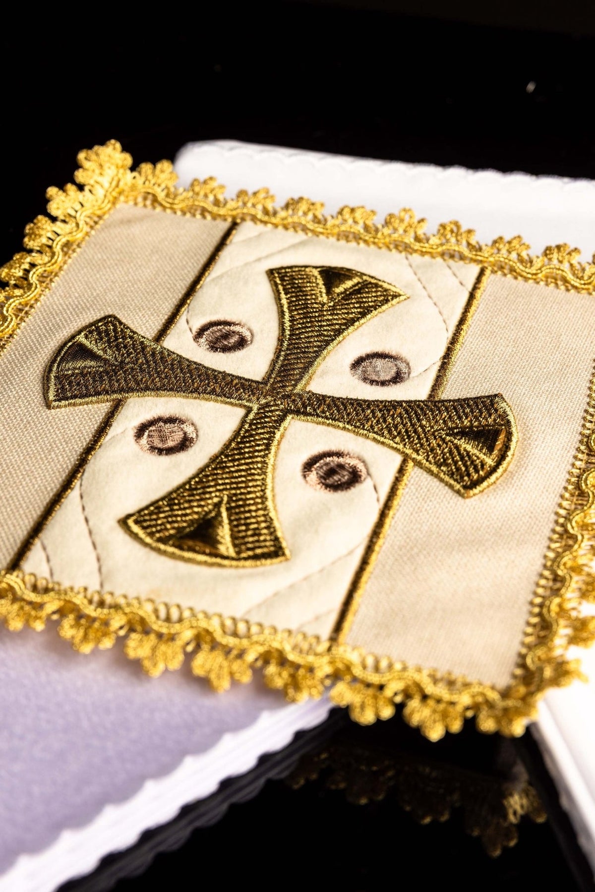 Altar linen set close-up showing embroidered gold cross and ornate gold trim