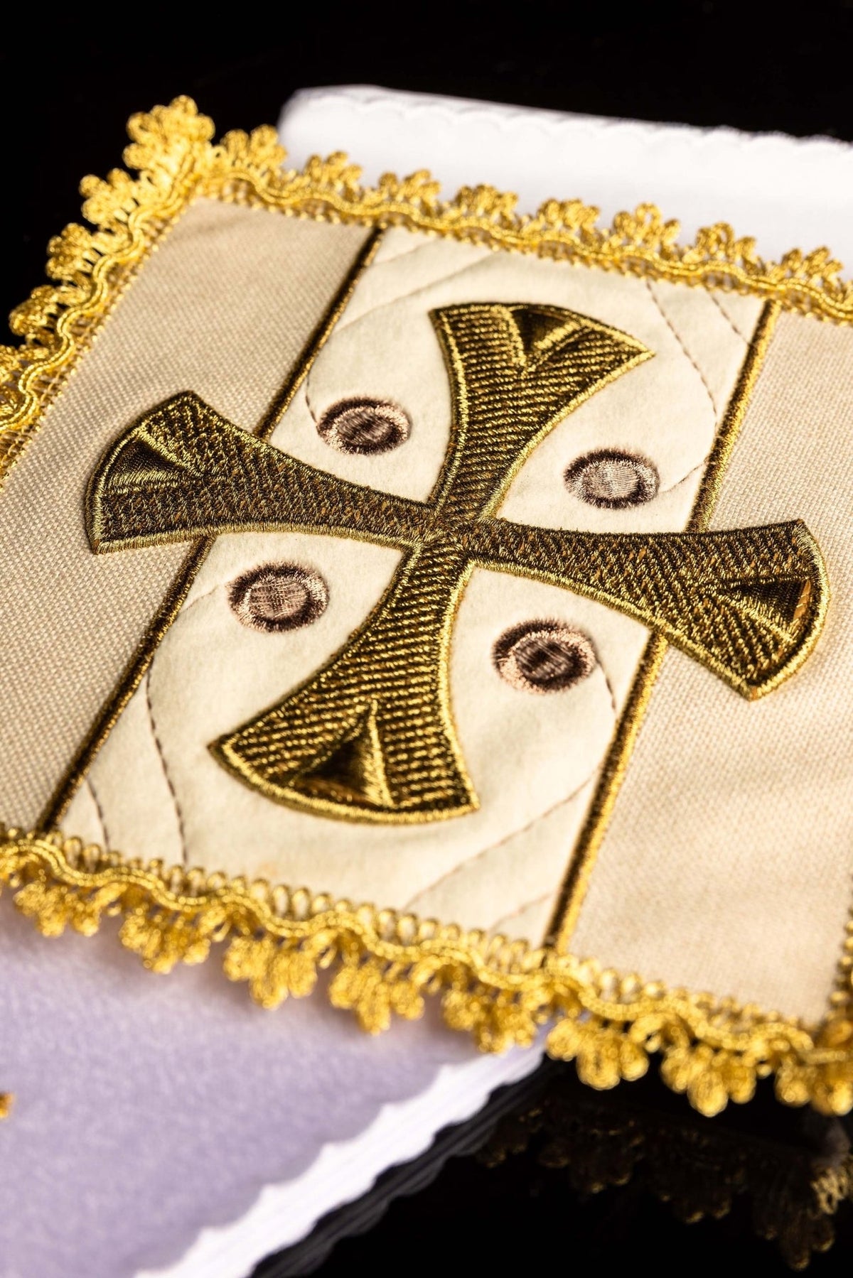 Altar linen set close-up of gold embroidered cross on ecru fabric