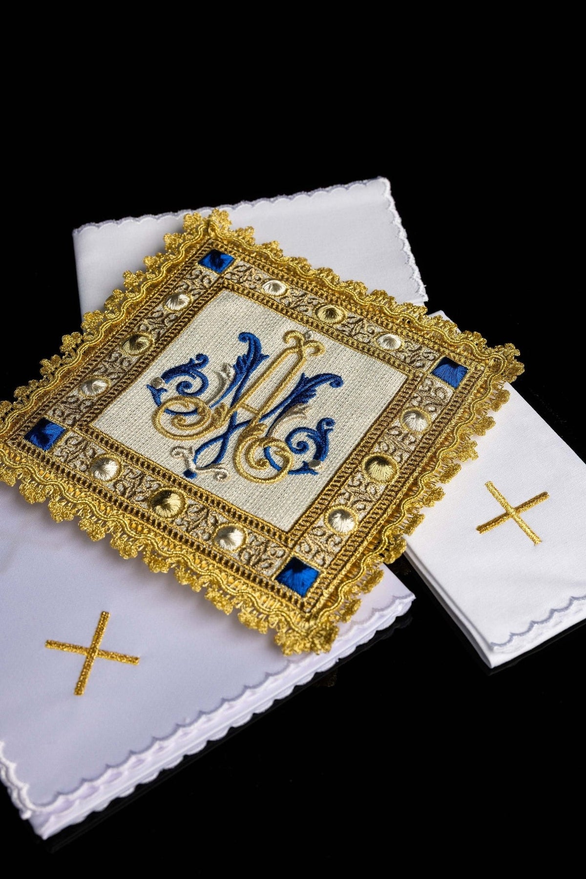 Altar linen set close-up showing blue and gold Marian symbol with ornate gold embroidery