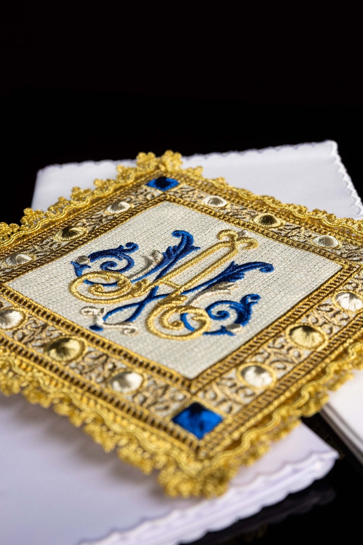 Altar linen set close-up of blue and gold Marian symbol and ornate embroidered border
