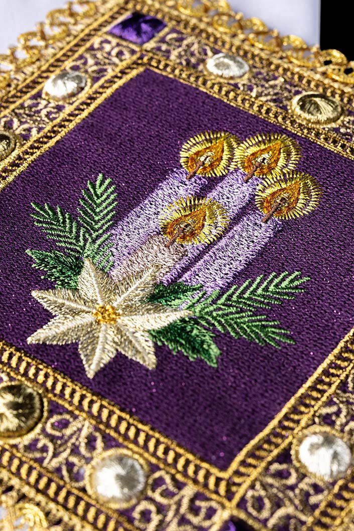 Advent altar linen set close-up showing four embroidered purple candles, green branches and white star