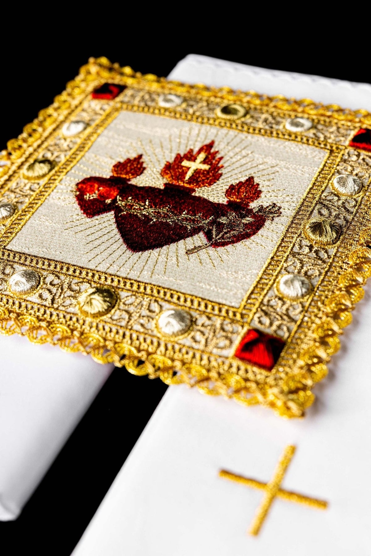 Altar linen set close-up showing the three red Sacred Hearts embroidery with ornate gold border