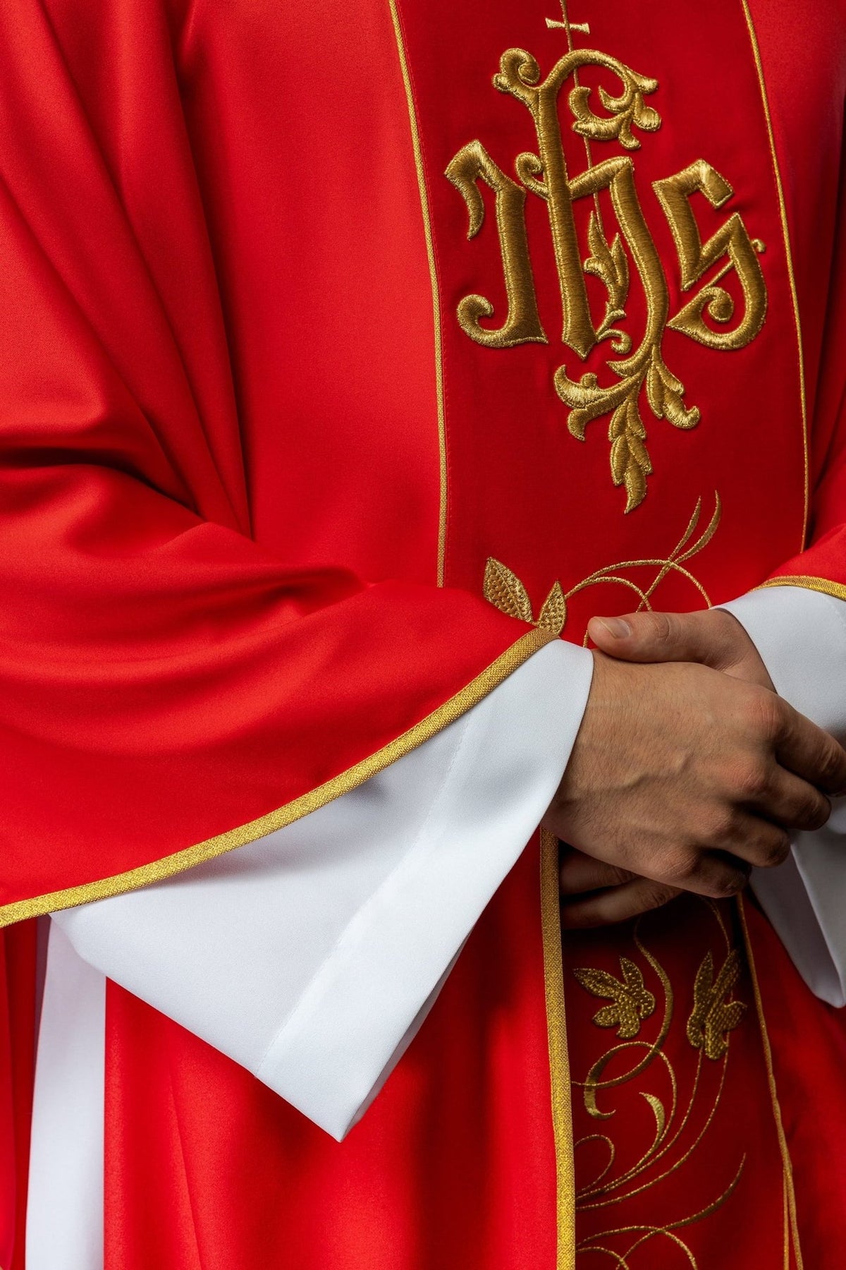 Red chasuble close-up of gold-edged stand-up collar and IHS embroidery