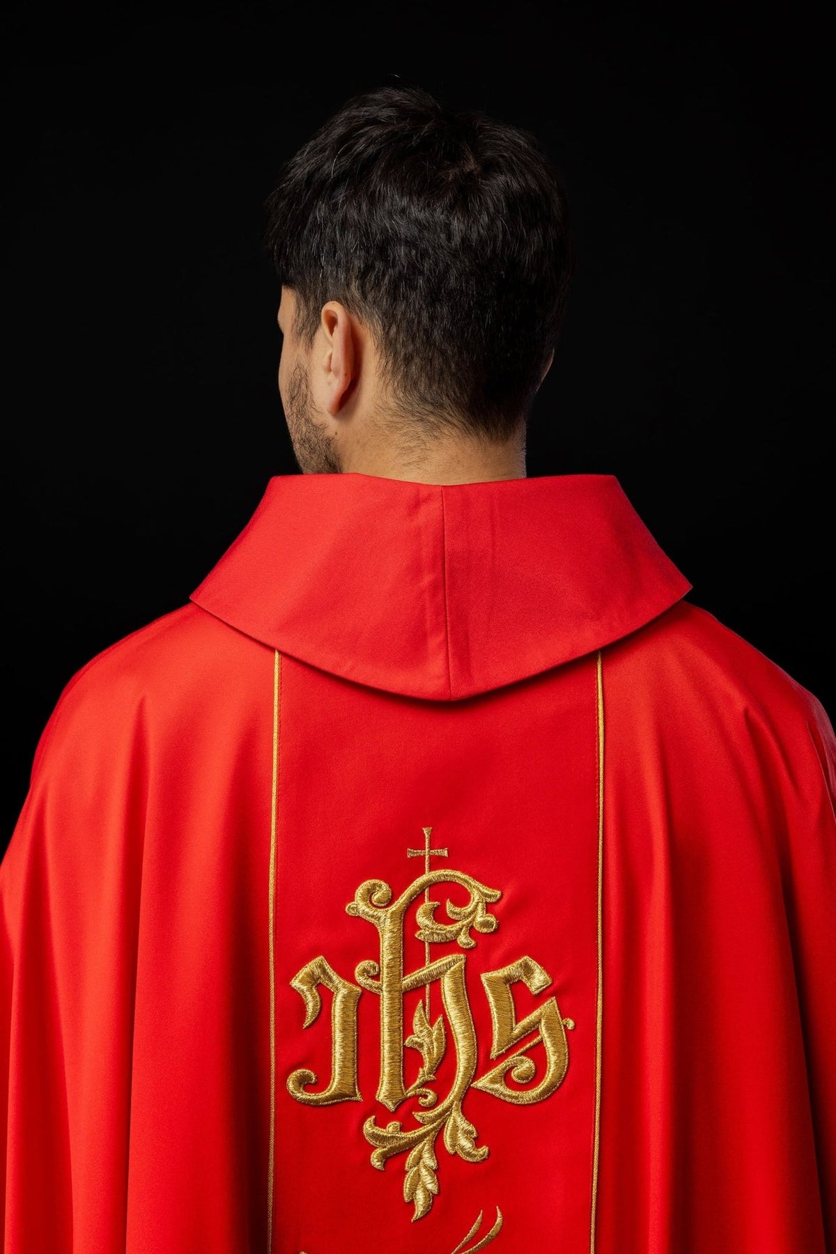 Red chasuble back view with gold IHS embroidery and floral orphrey