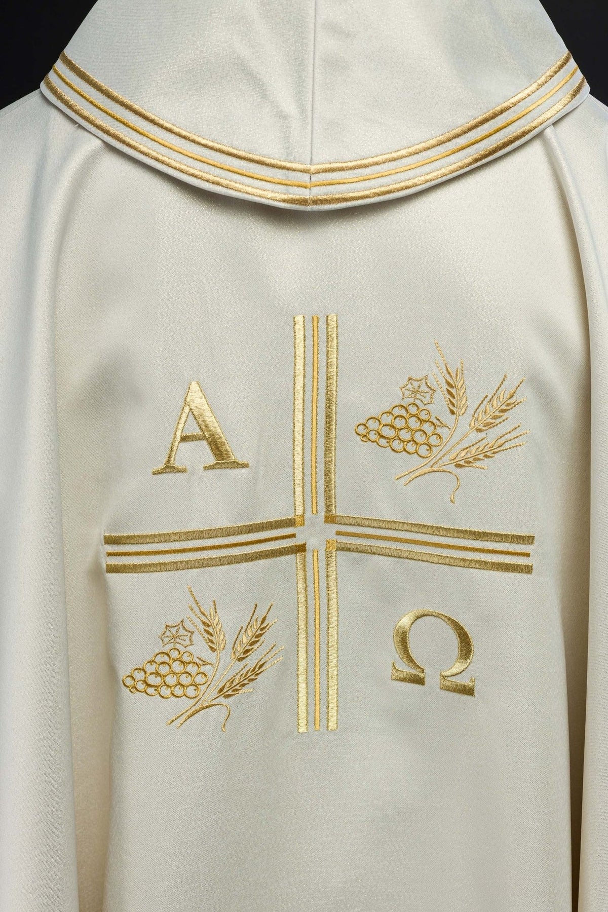 Ecru chasuble front close-up showing gold cross and Alpha Omega embroidery