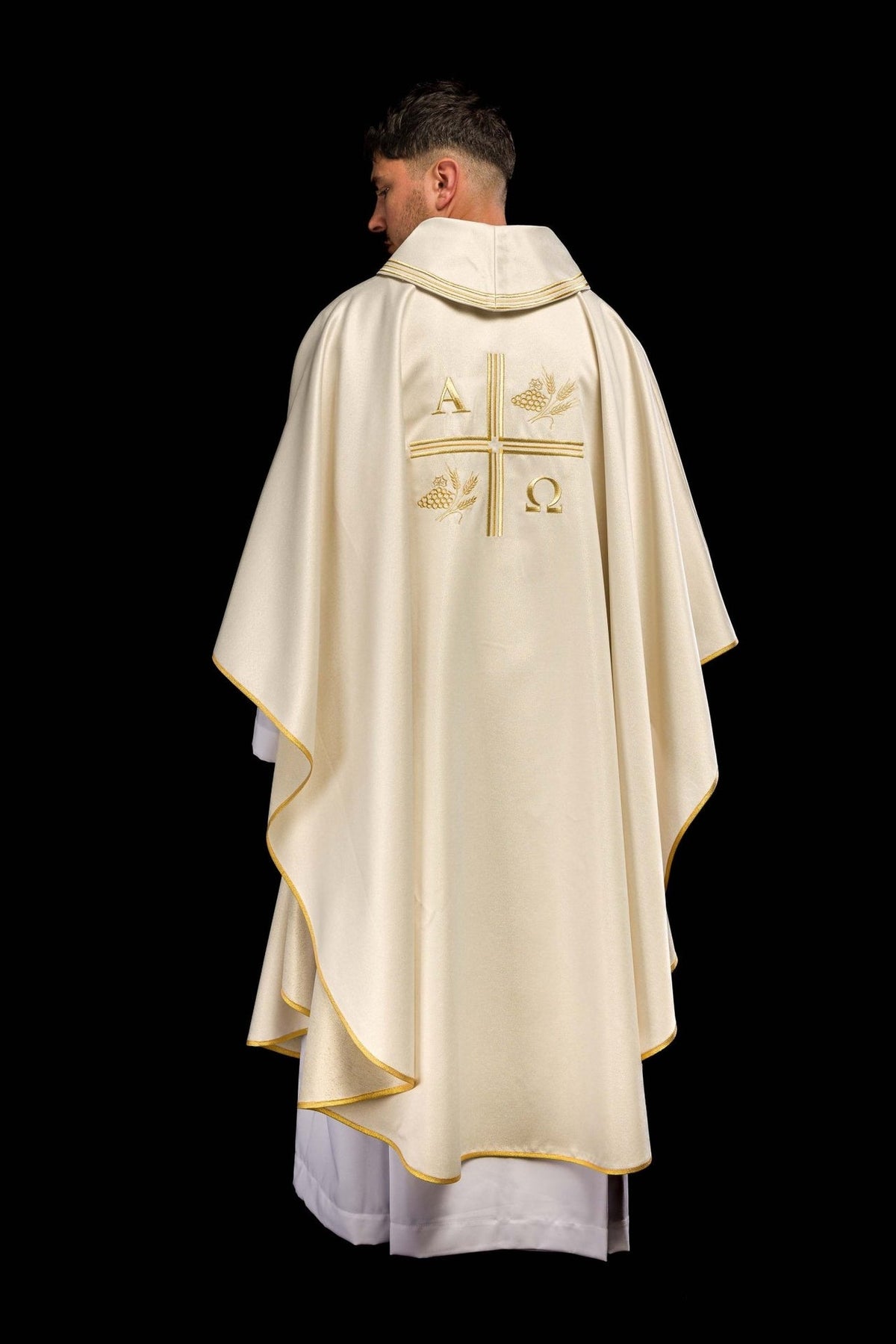 Ecru chasuble back view showing gold trim and embroidered motifs