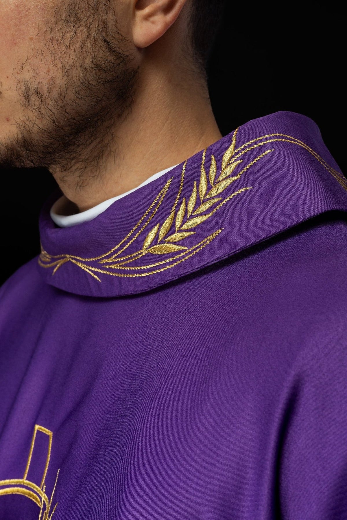 Purple chasuble sleeve close-up with gold trim and satin lining