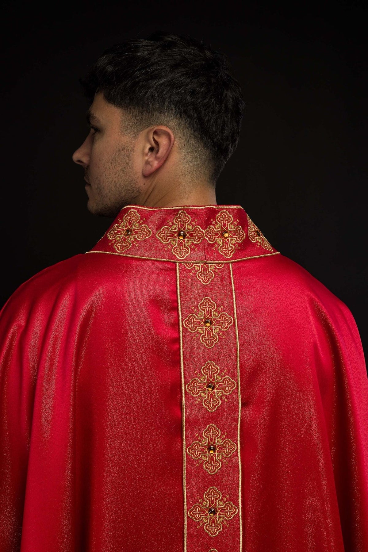 Red chasuble back view with embroidered orphrey and stone-set collar