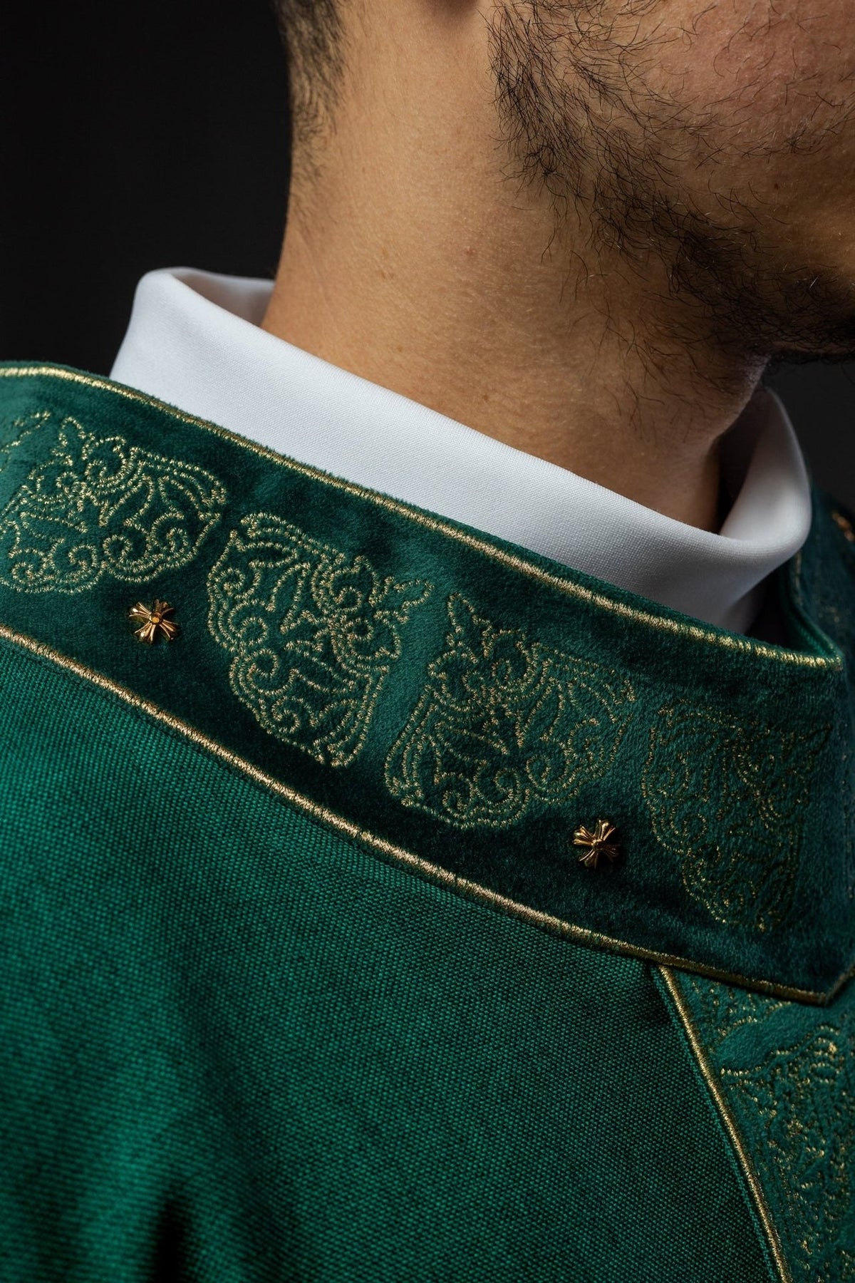 Green chasuble close-up showing gold embroidered stand-up collar