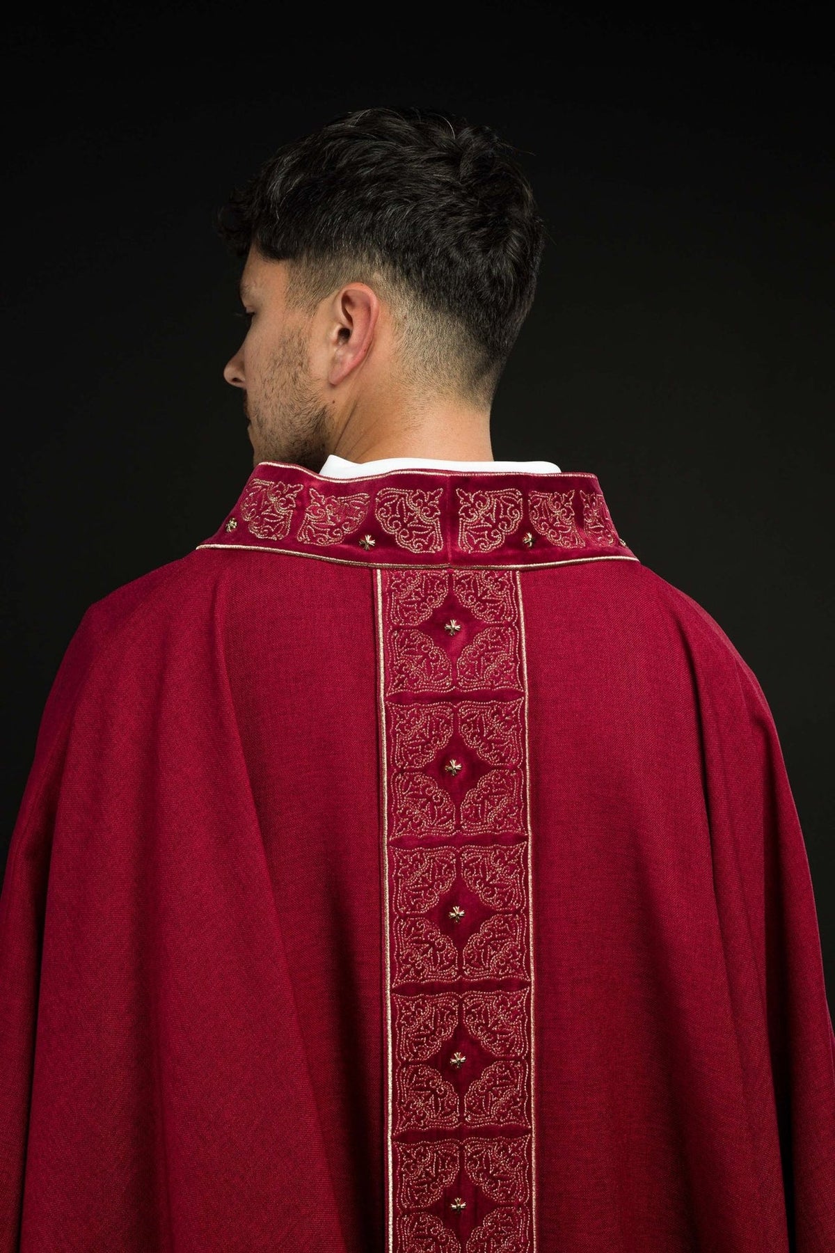 Red chasuble back view showing the full embroidered orphrey