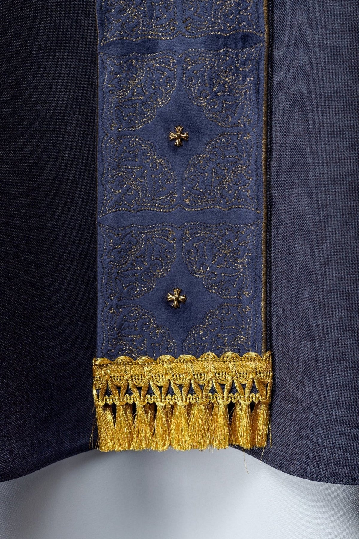Purple chasuble orphrey close-up with gold embroidery and small cross details