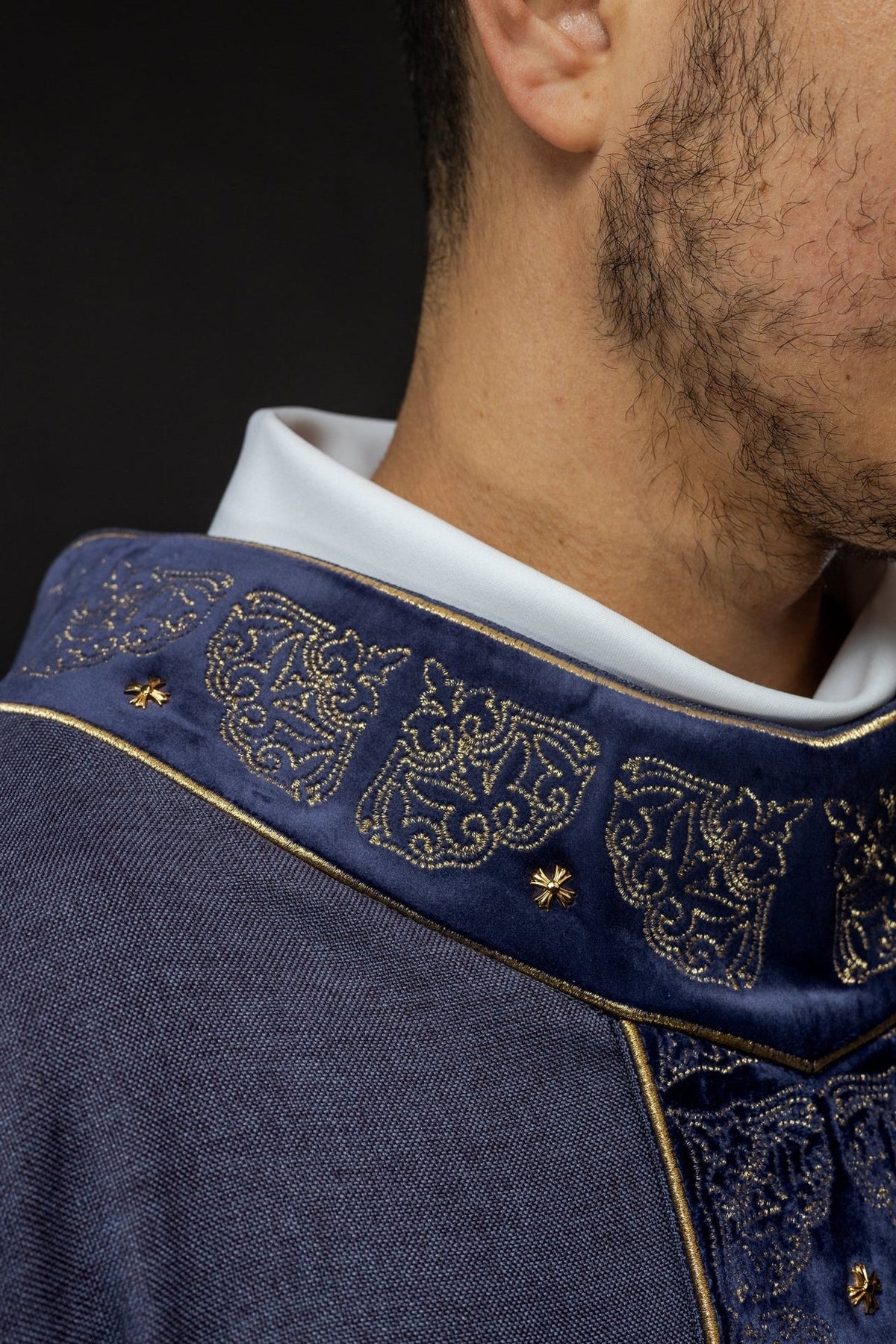Purple chasuble orphrey detail showing gold embroidery, cross motifs and fringe