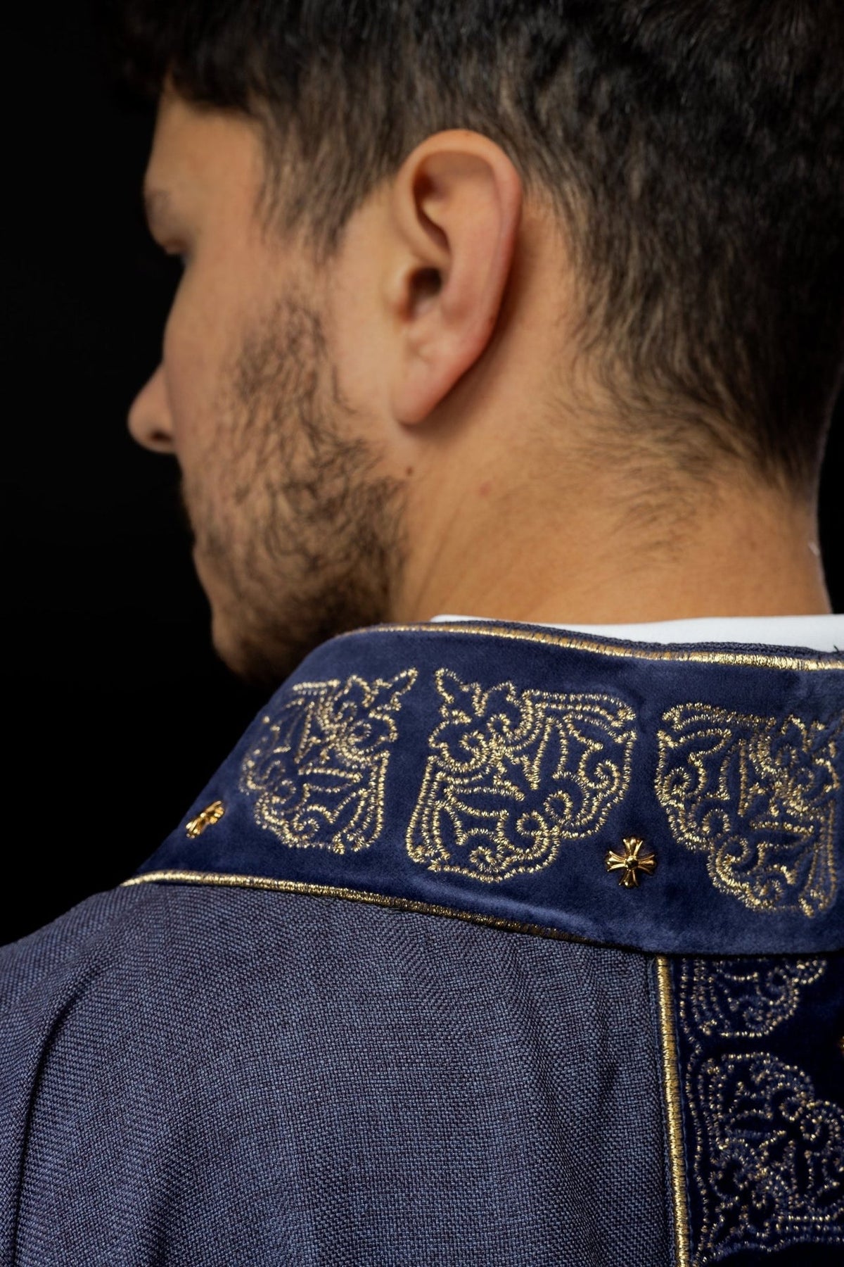 Purple chasuble stand-up collar close-up with gold embroidery and edging