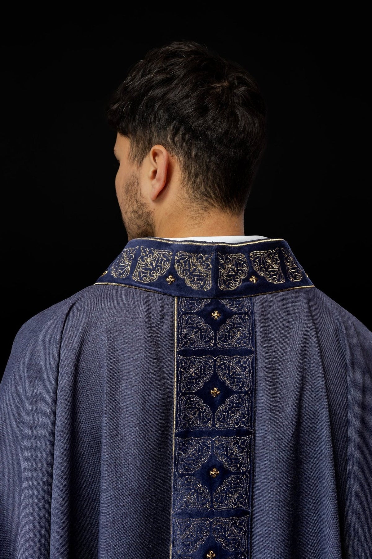 Purple chasuble back close-up showing the embroidered collar and orphrey