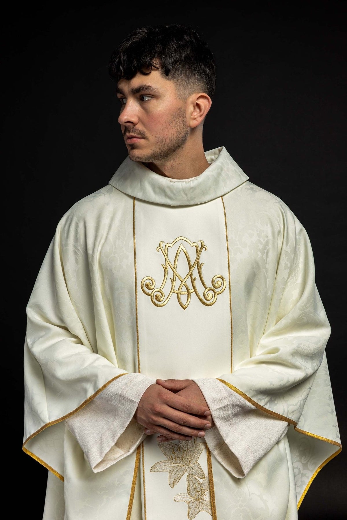 Chasuble front close-up with gold Marian monogram and embroidered lilies