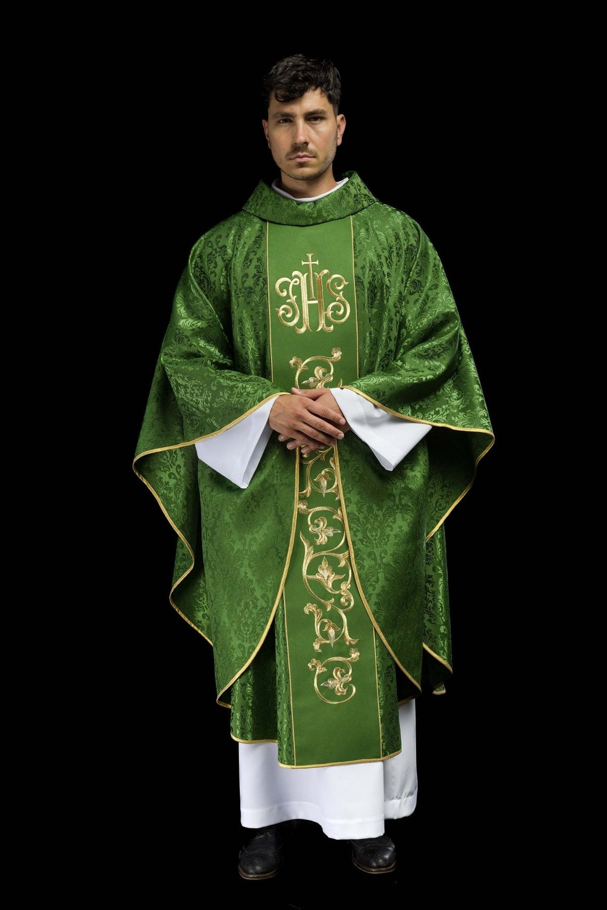 Green chasuble worn in full front view with gold IHS embroidery