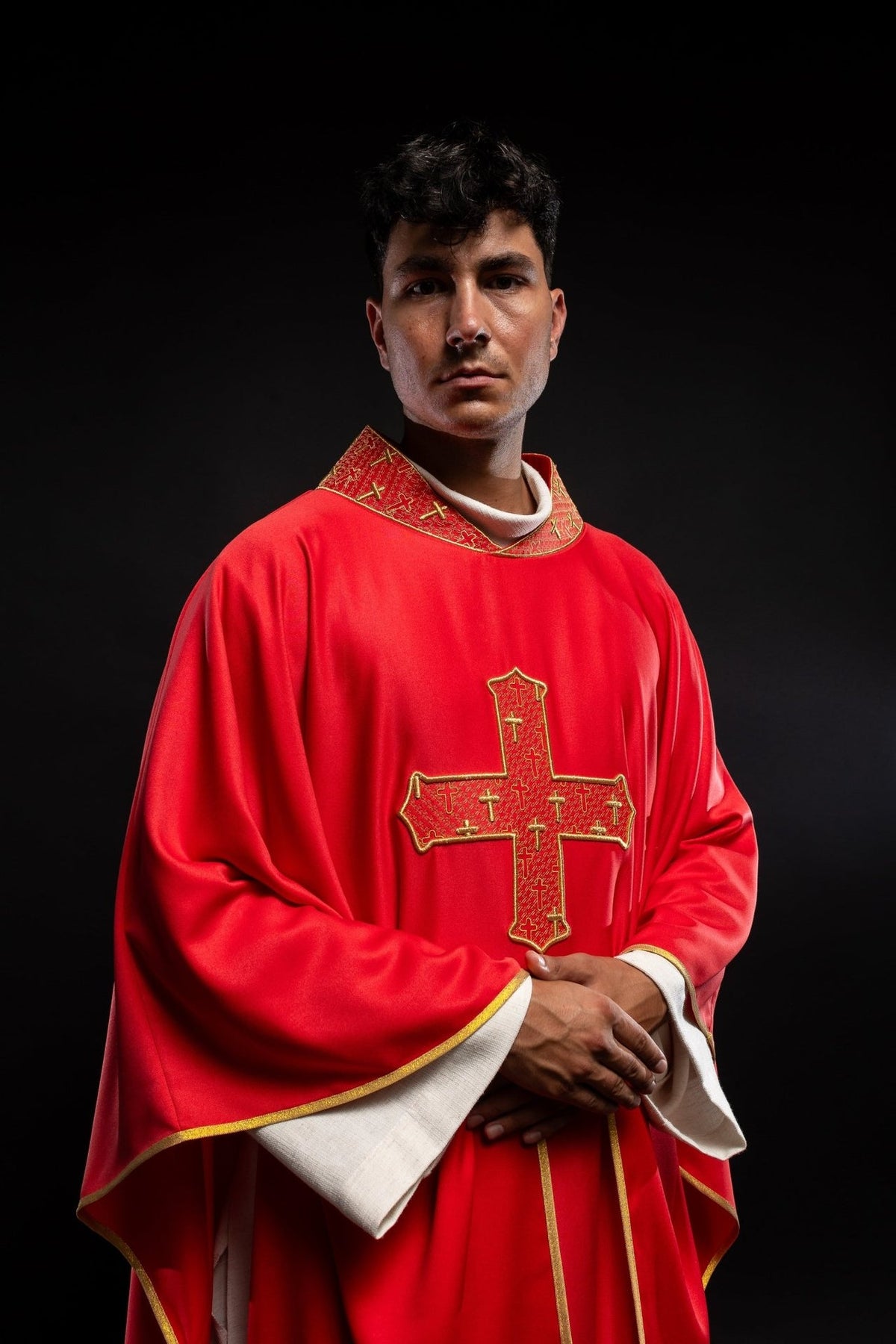 Red chasuble front view with large embroidered cross and gold edging