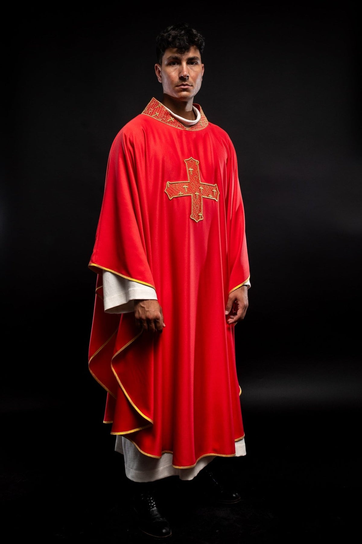 Red chasuble side view showing embroidered cross, collar and gold edging