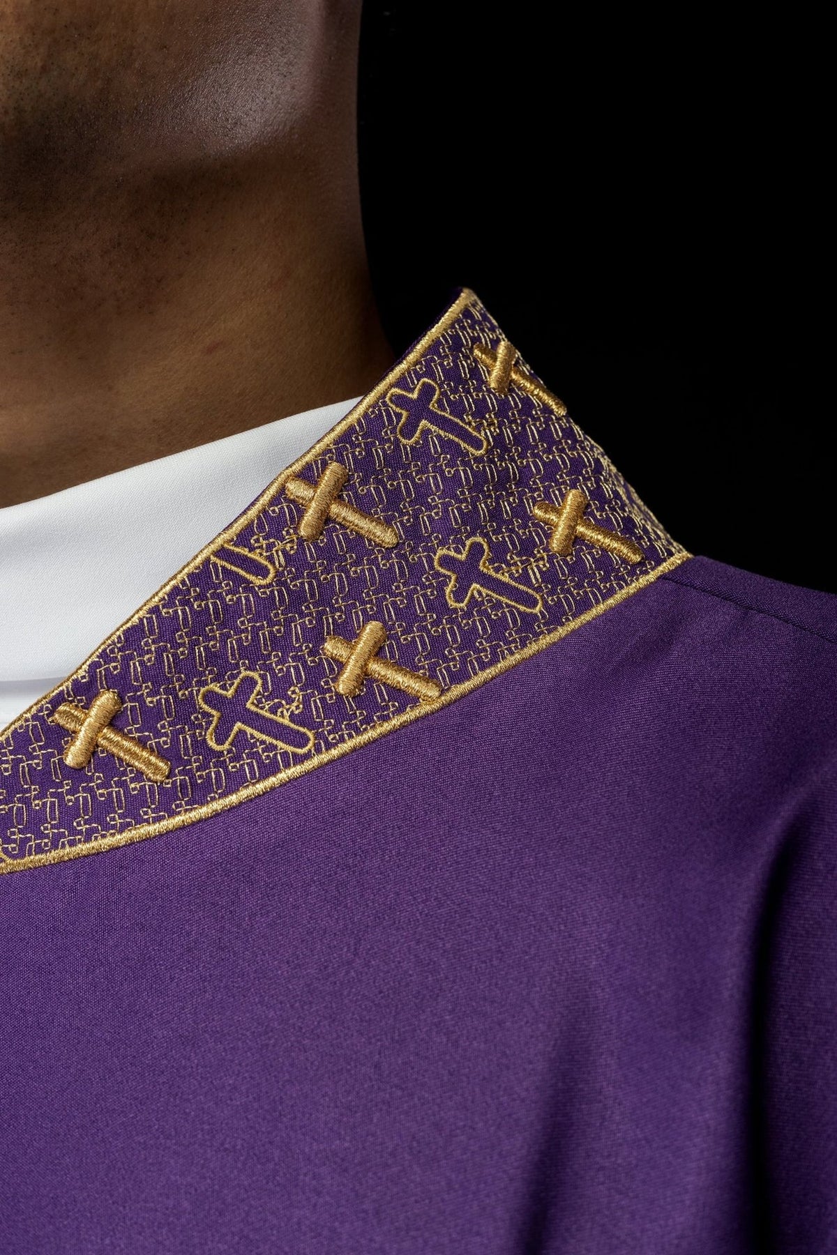 Purple chasuble collar close-up with gold cross embroidery