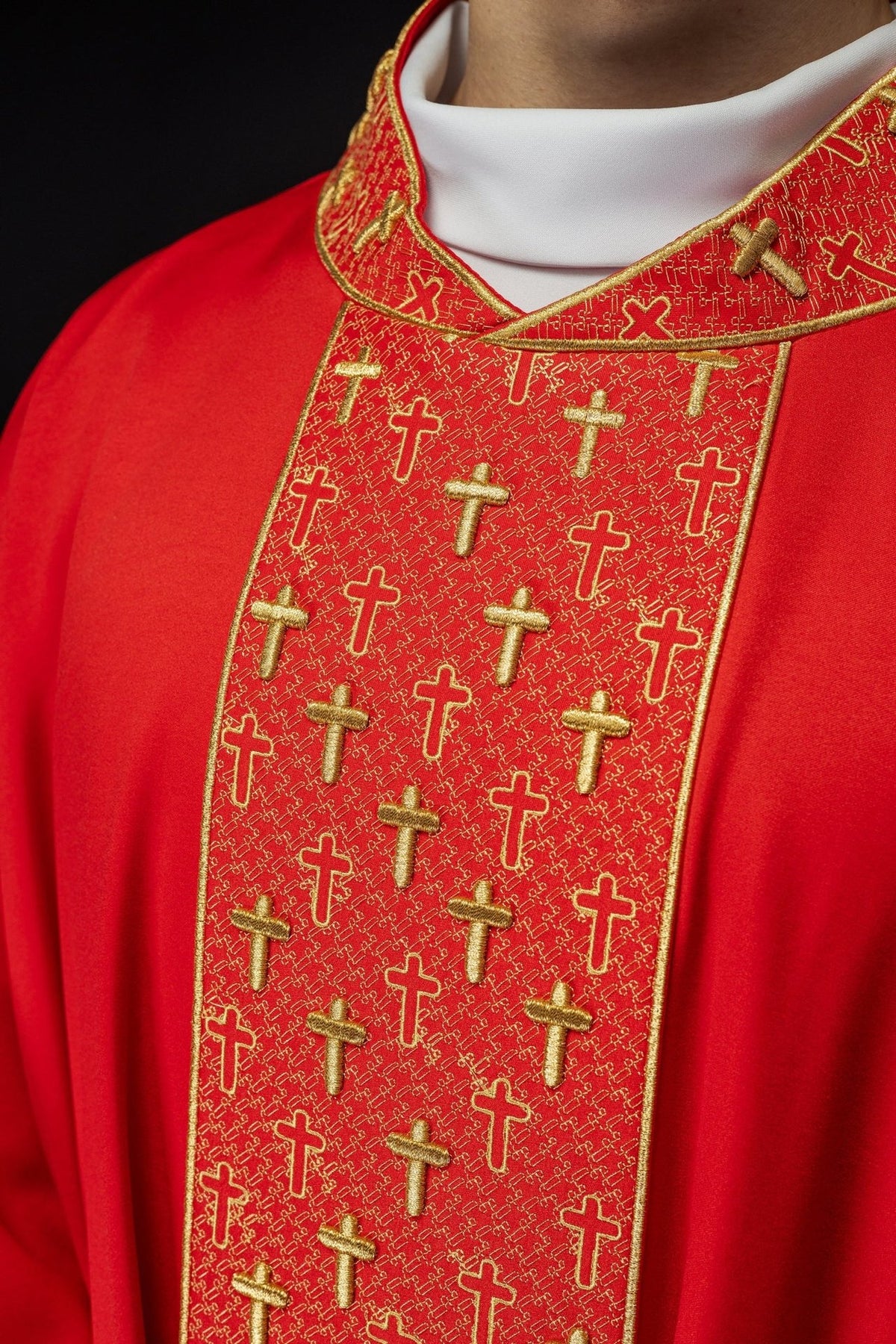 Red chasuble close-up of embroidered front orphrey with gold crosses