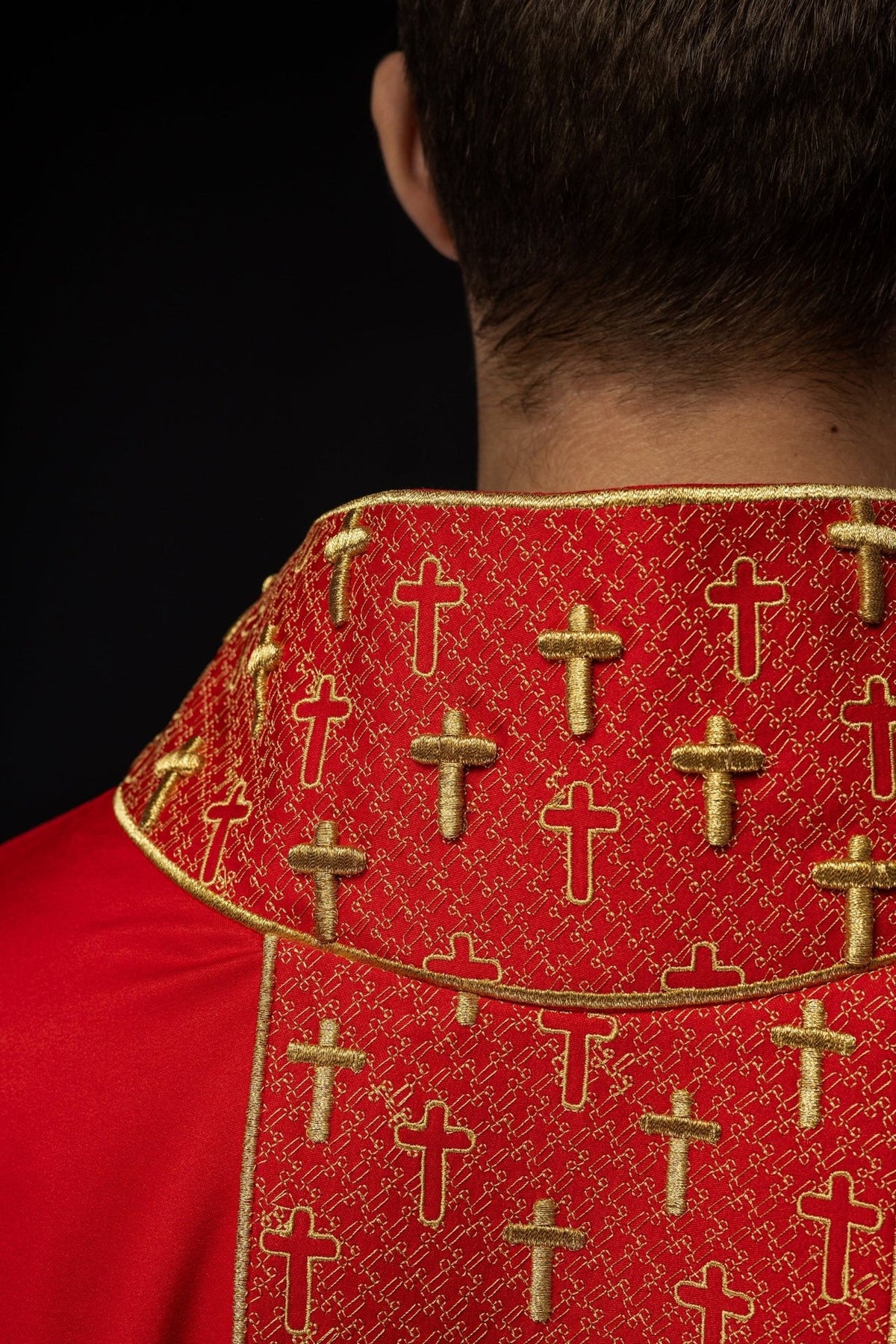 Red chasuble back collar close-up with gold cross embroidery