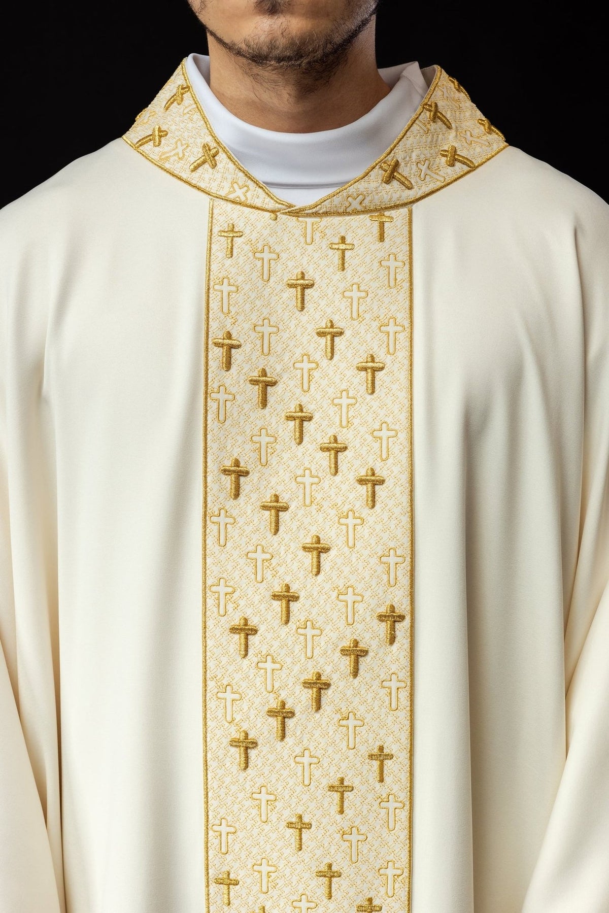 Ecru chasuble, close-up front view of gold cross embroidery