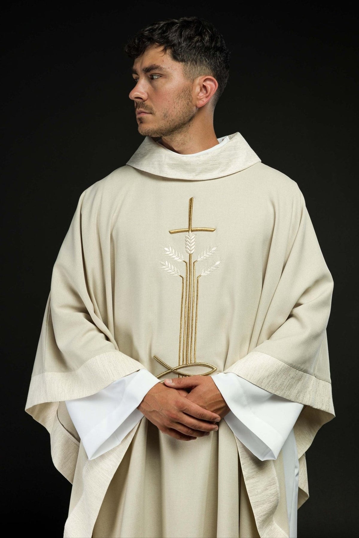 Ecru chasuble worn front view with cross, wheat and fish motif