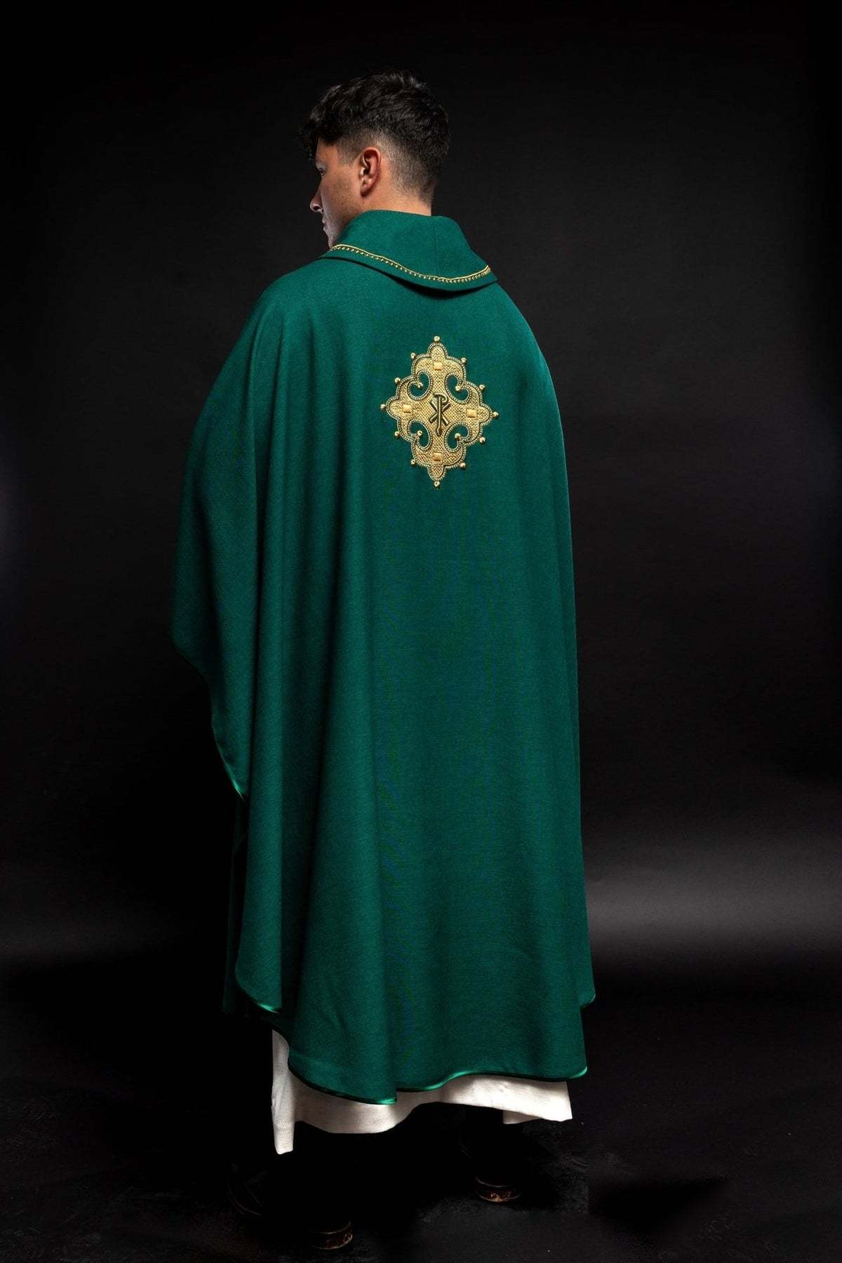 Green chasuble rear view showing embroidered cross and gold collar trim