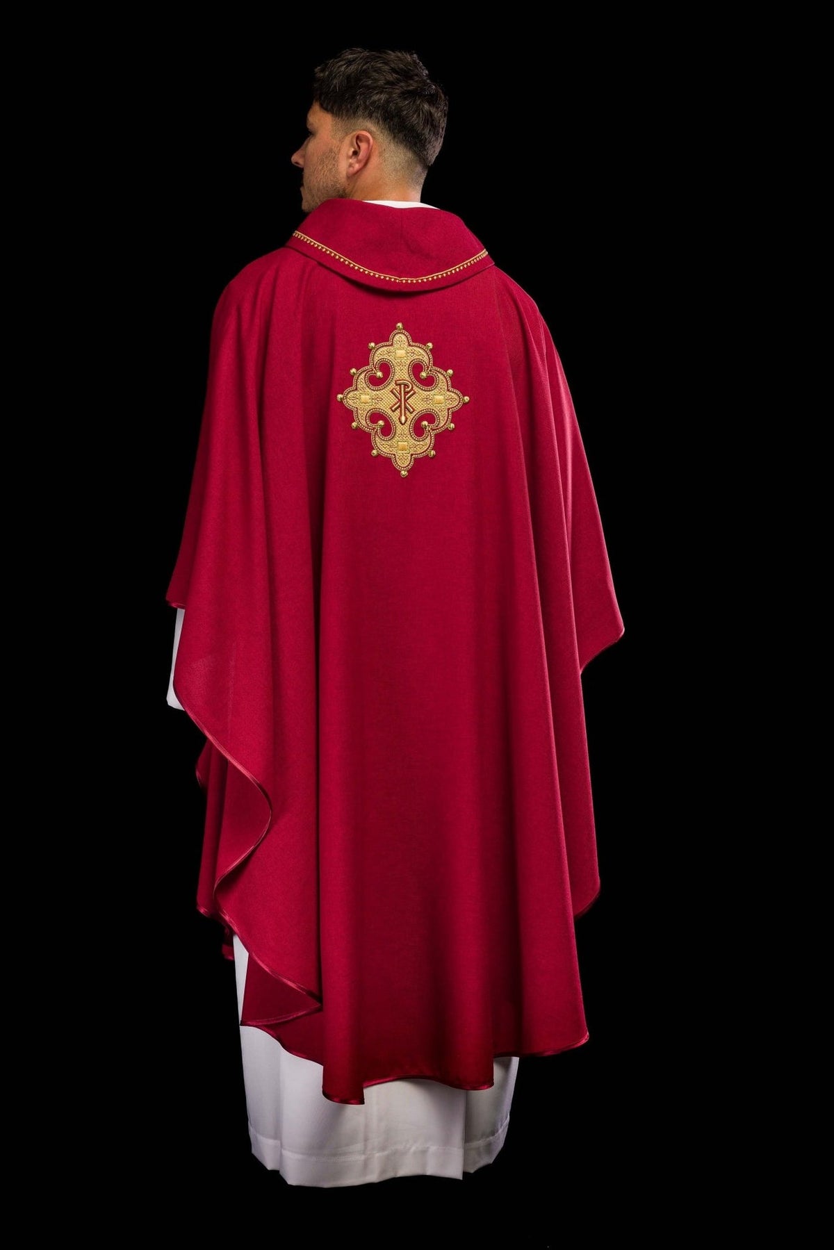 Red chasuble back view with embroidered cross and gold collar trim