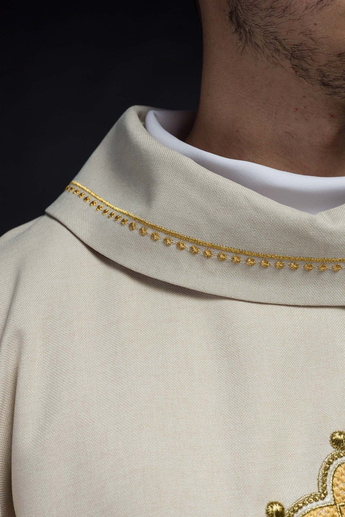 Ecru chasuble collar close-up with gold trim