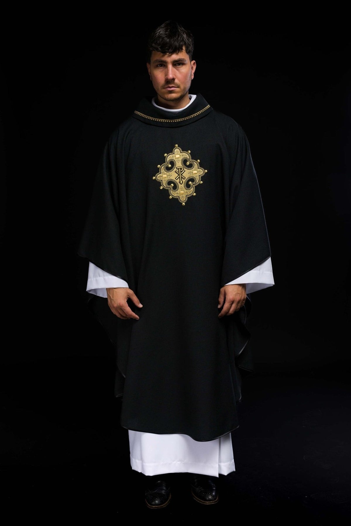 Black chasuble, full front view with embroidered gold cross