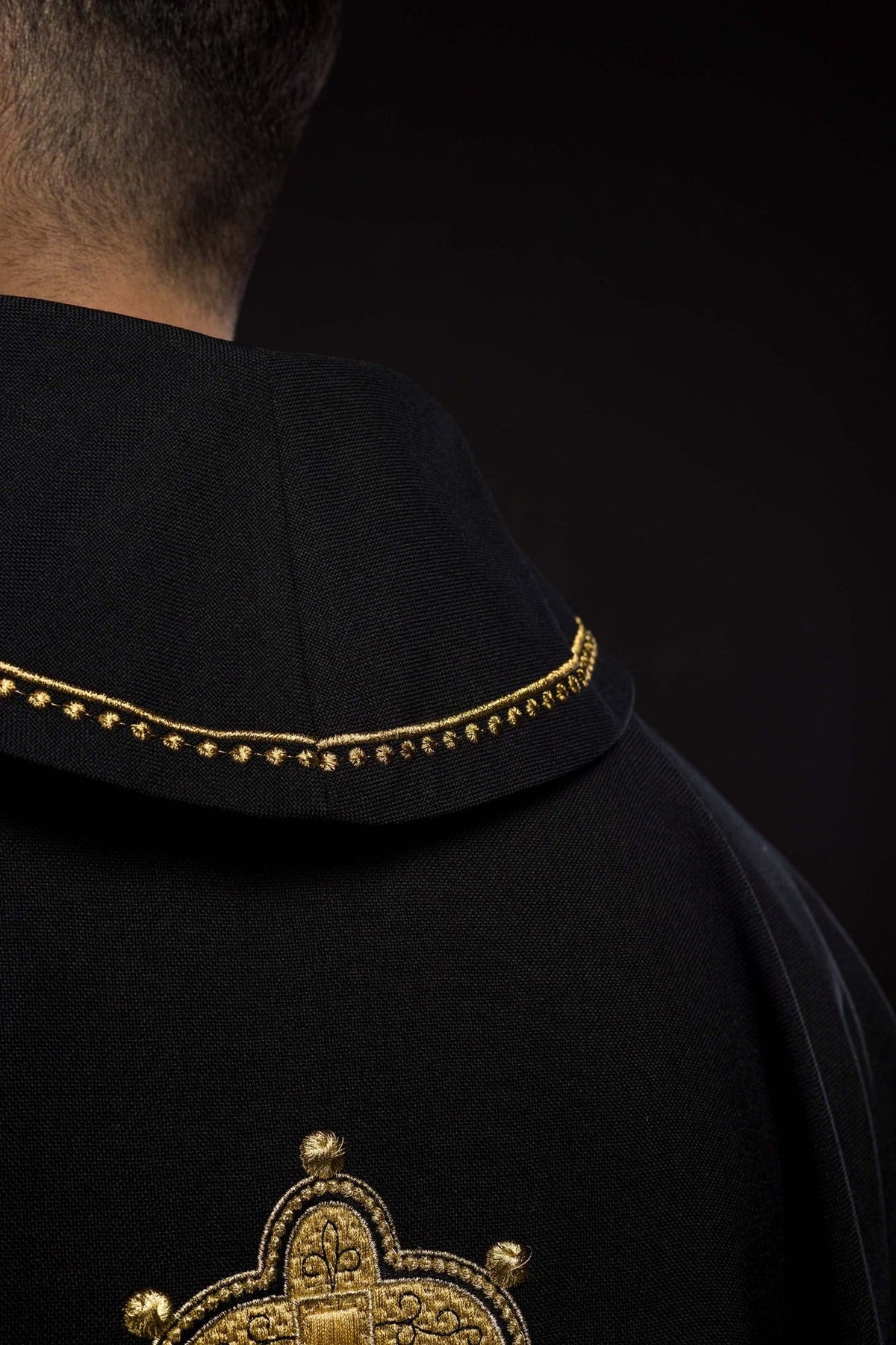 Black chasuble close-up of gold collar trim