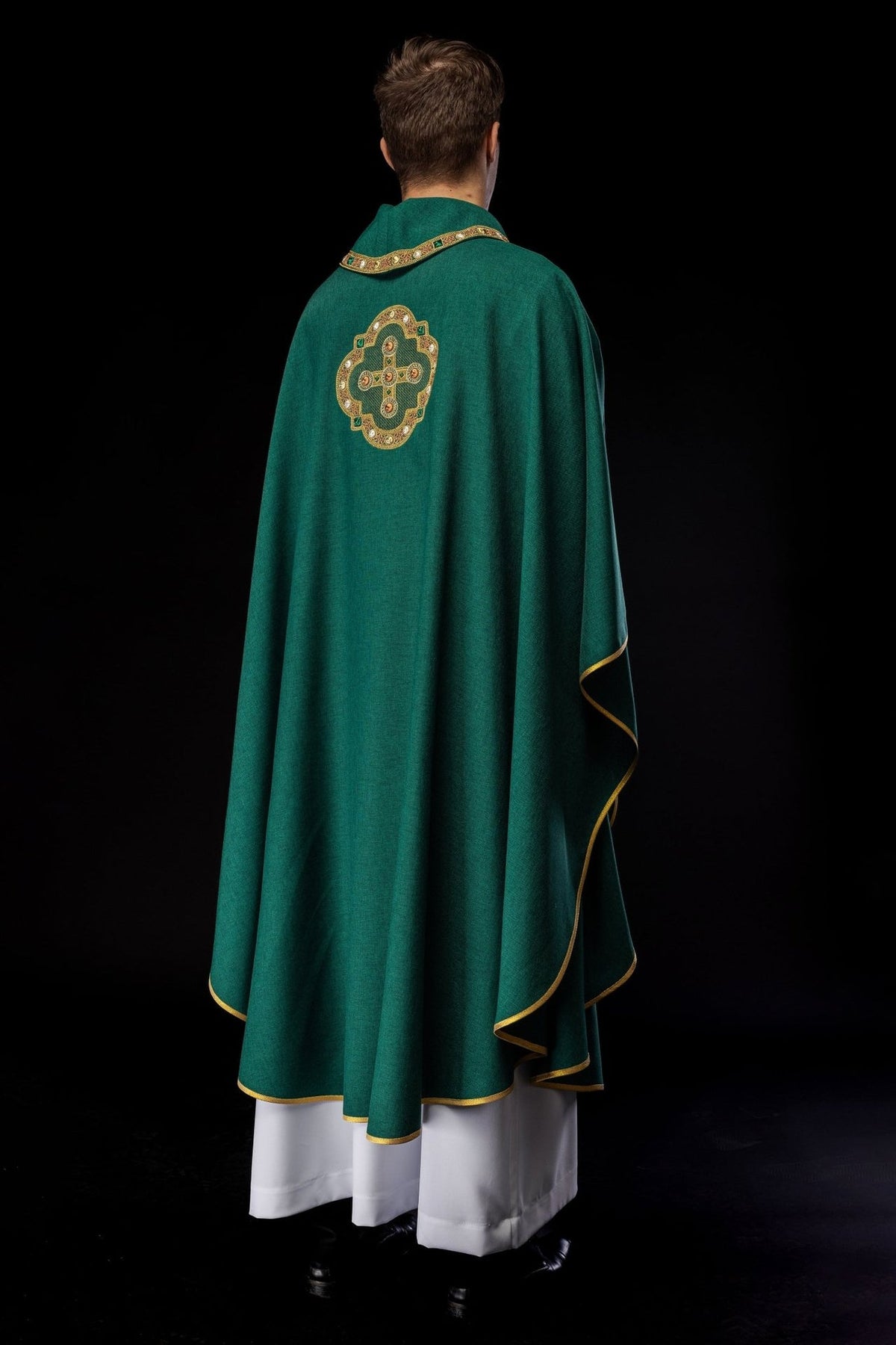 Green chasuble back view showing embroidered cross and gold edging