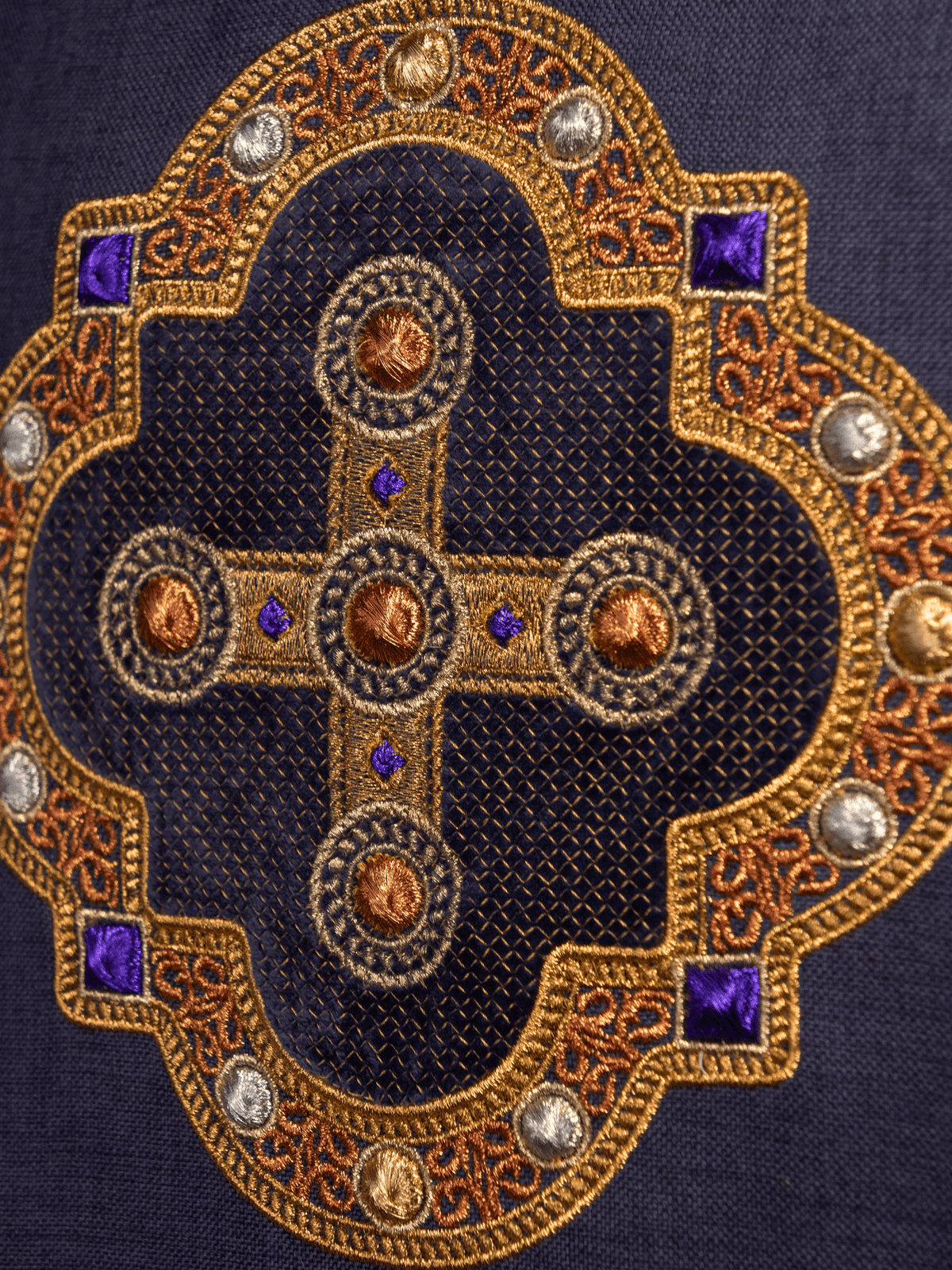 Purple chasuble close-up of embroidered gold cross with purple accents
