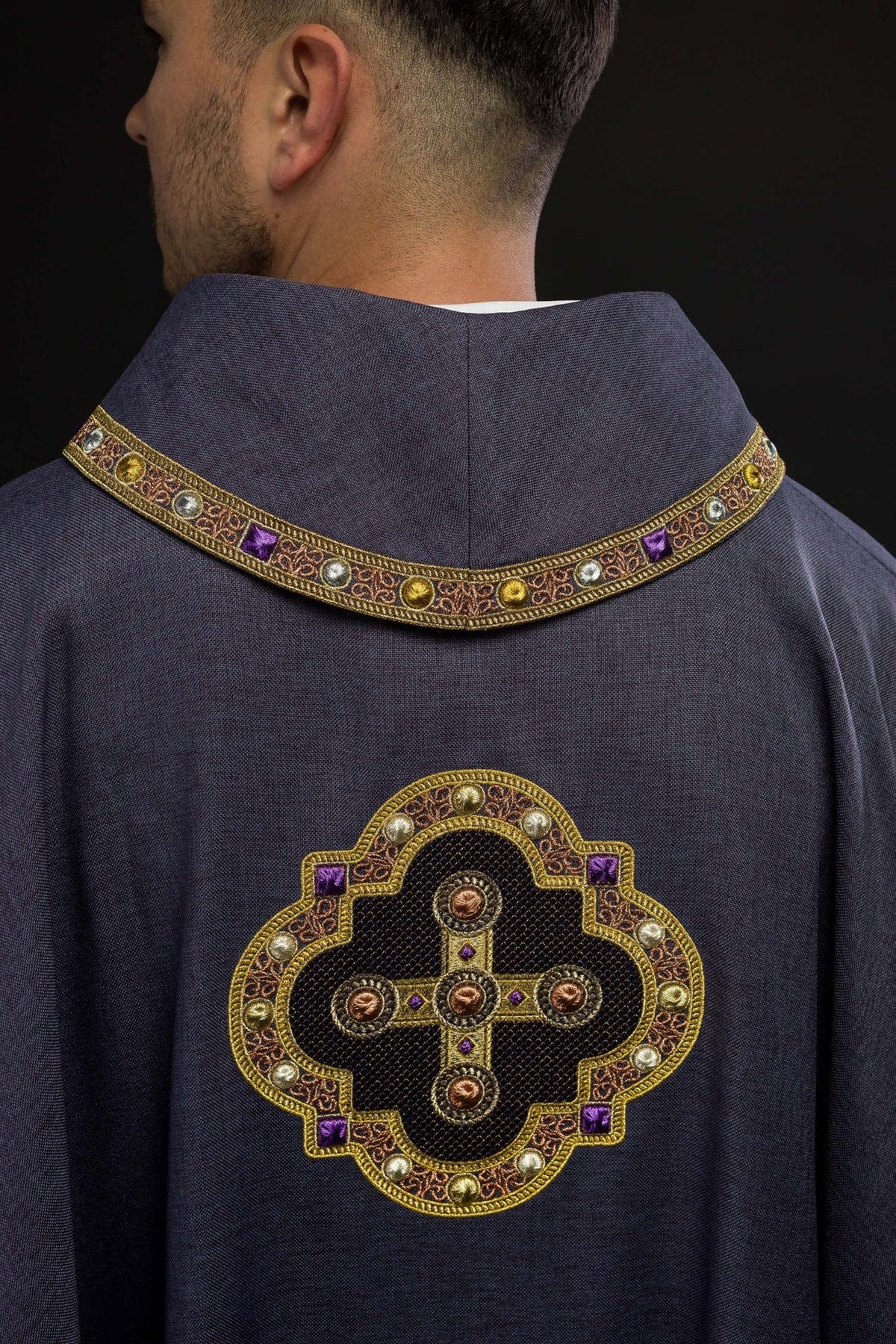 Purple chasuble back view with gold-trimmed cross embroidery