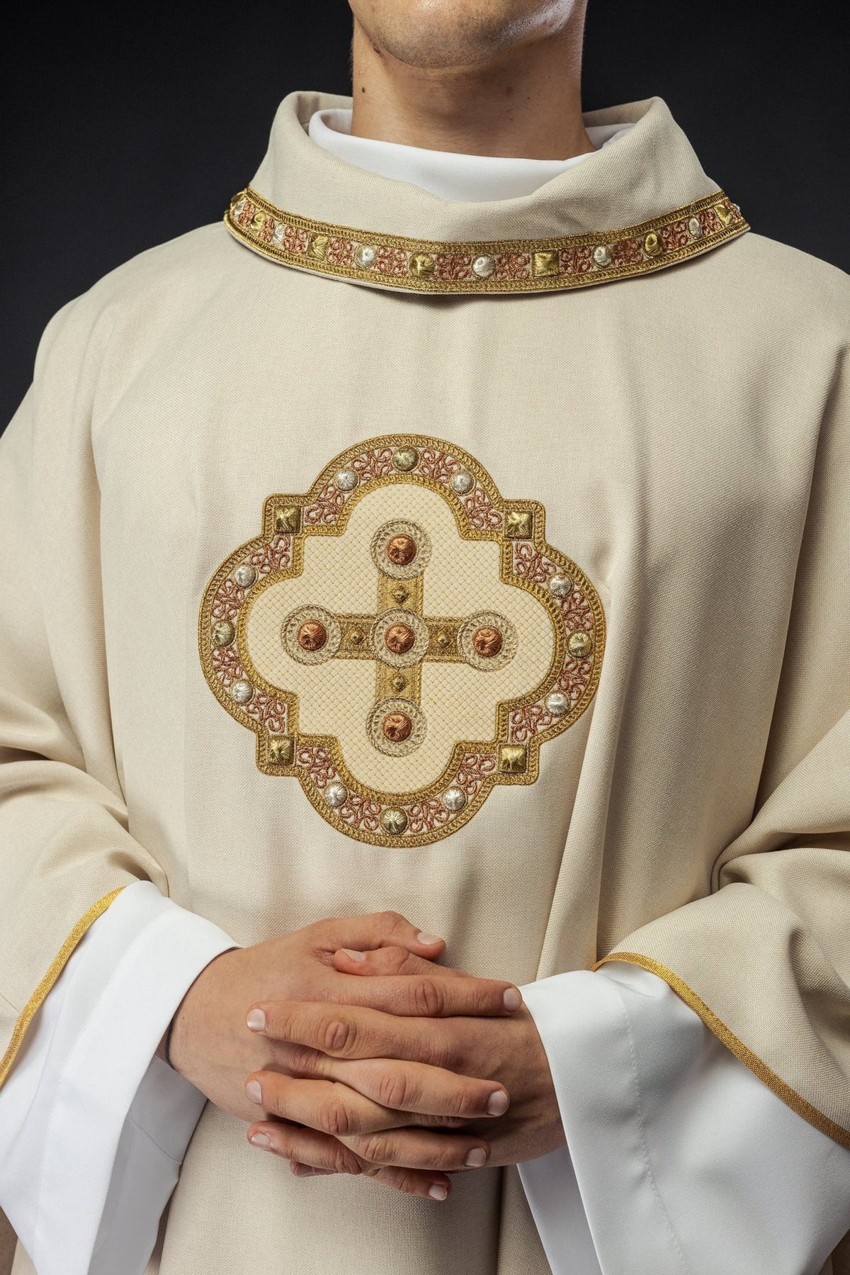 Ecru chasuble, front close-up of embroidered gold cross and collar trim