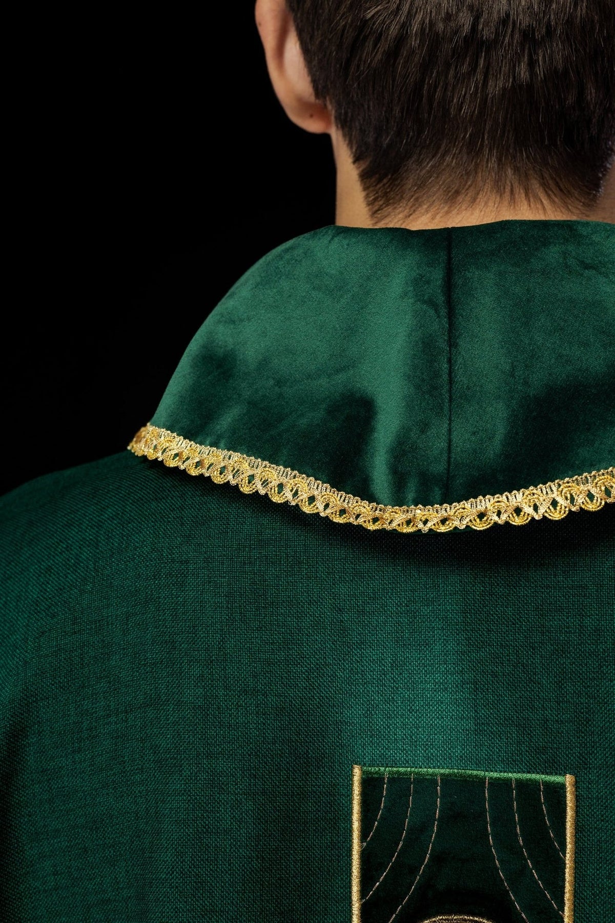 Green chasuble back view with gold trim and embroidered cross panel