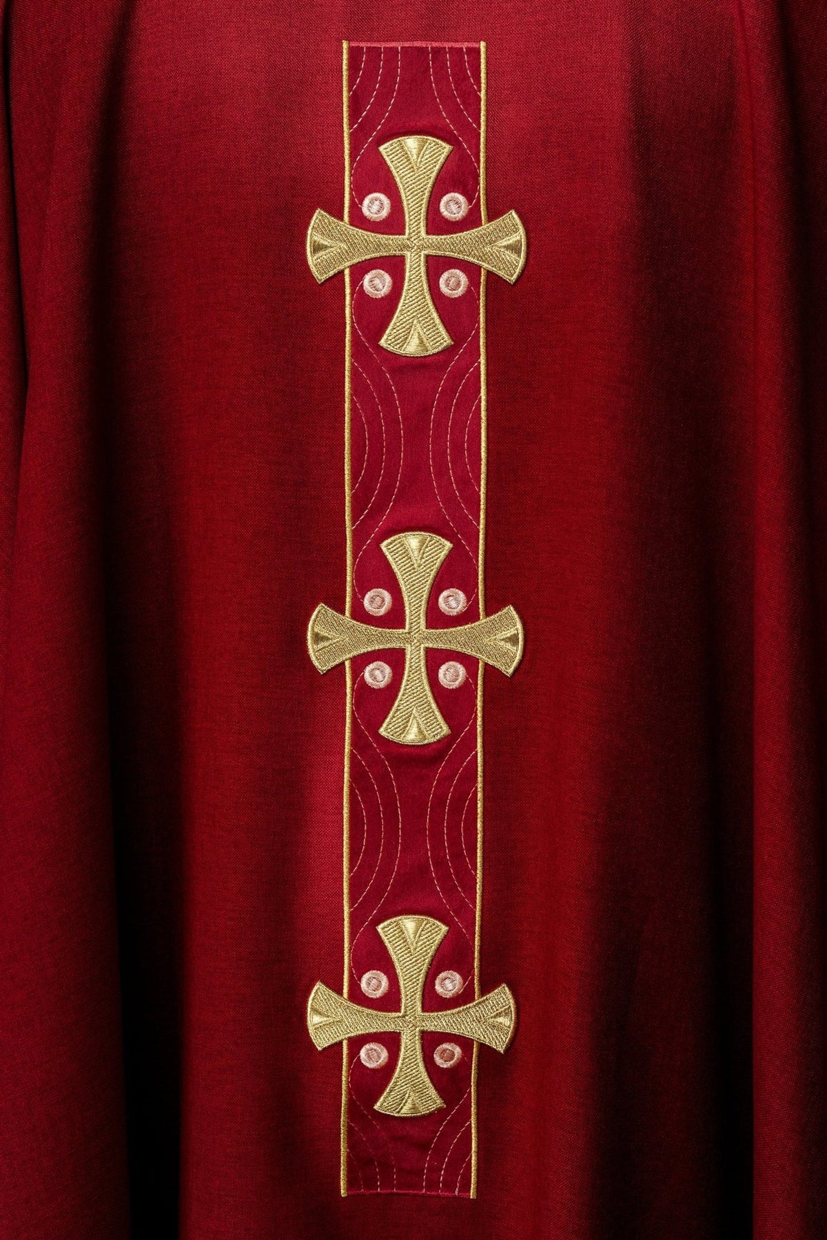 Red chasuble front detail with three embroidered gold crosses