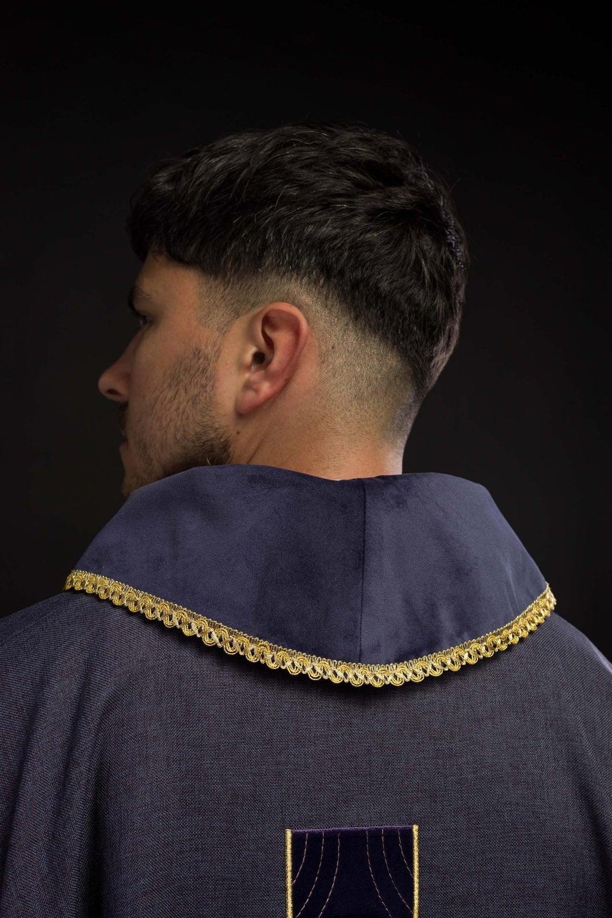 Purple chasuble back view with gold collar trim