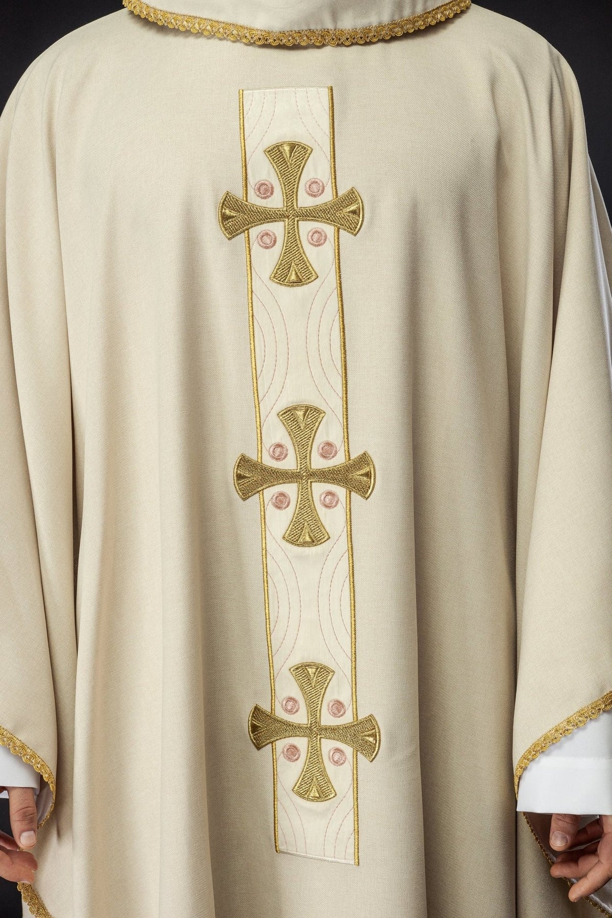 Ecru chasuble front close-up showing embroidered gold crosses and central panel
