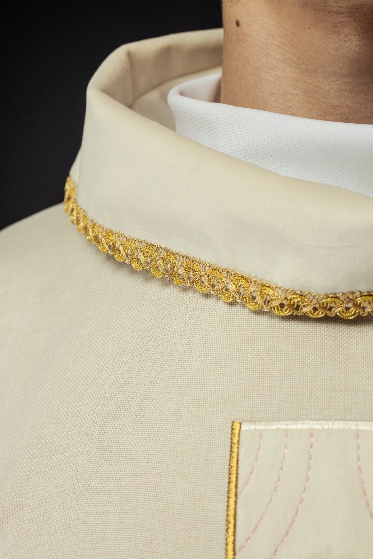 Ecru chasuble collar close-up with gold trim