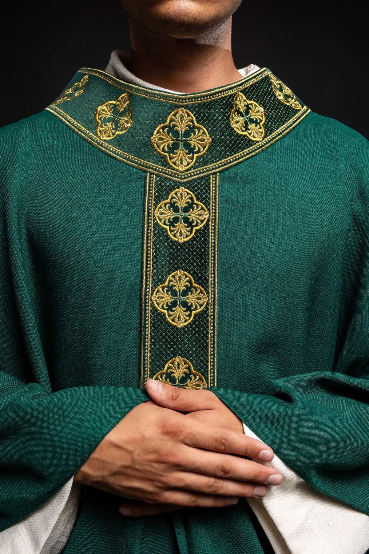 Green chasuble close-up showing gold embroidery on the orphrey and collar