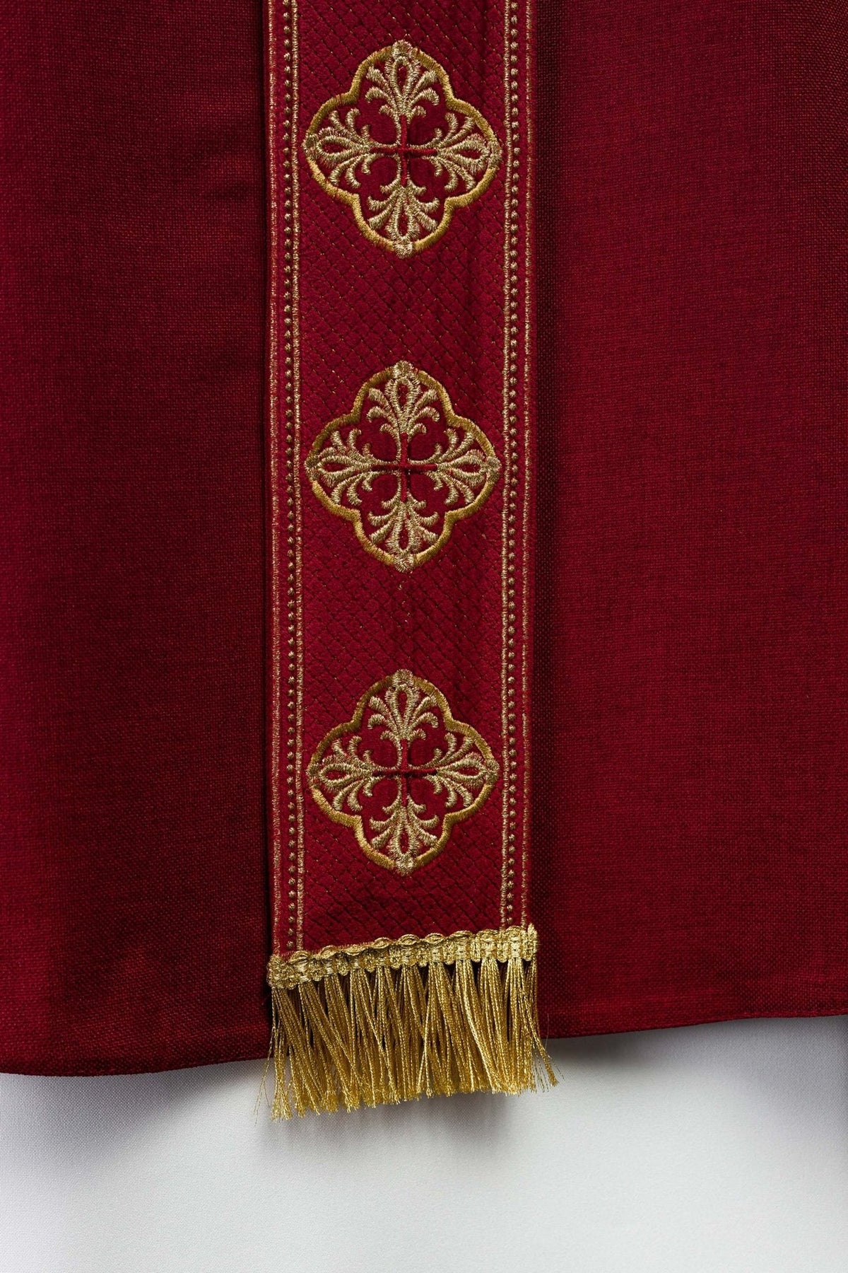 Red chasuble embroidered orphrey detail with gold motifs and border